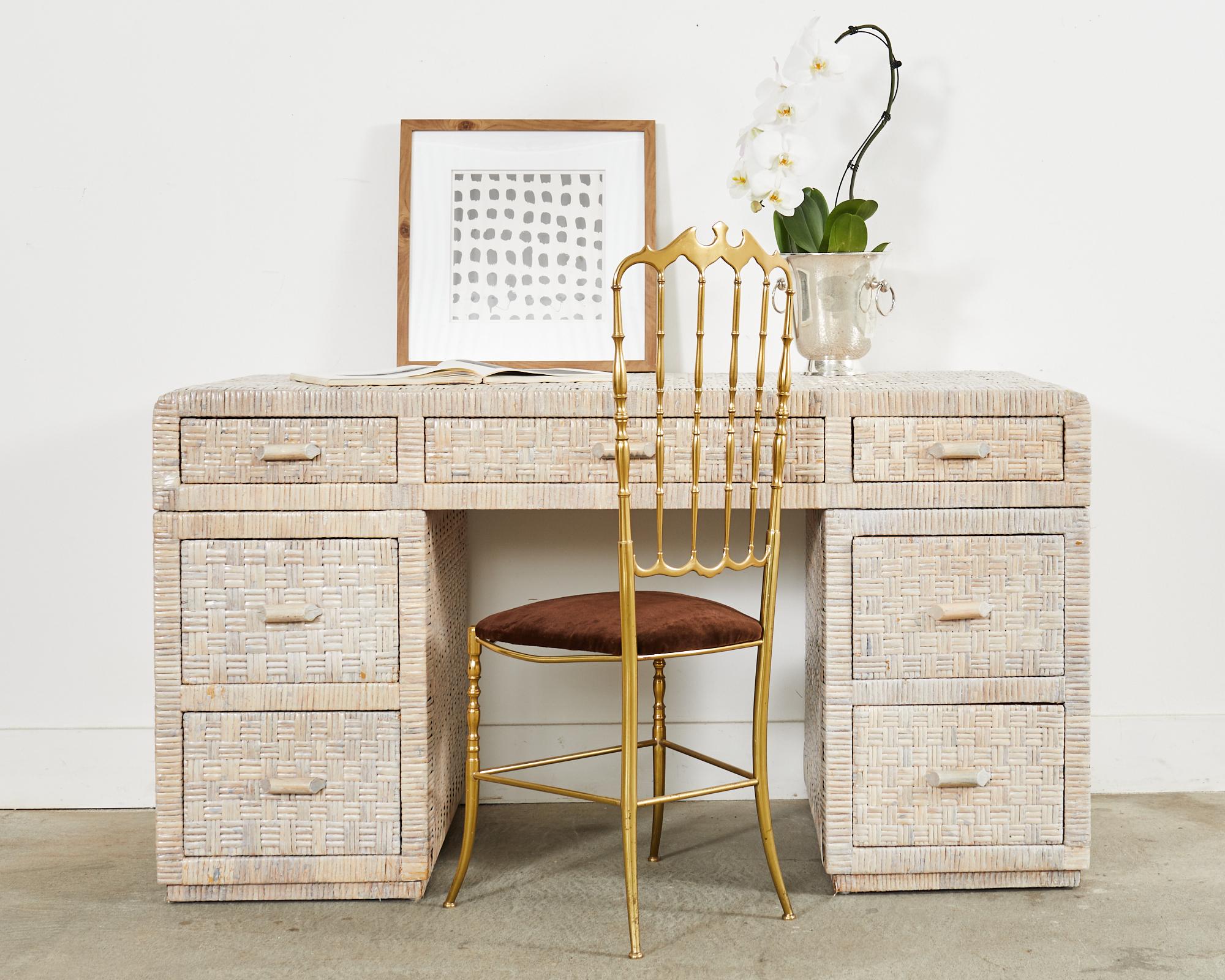 Stylish kneehole or pedestal desk featuring a wood frame covered with basketweave rattan wicker. The three piece desk is embellished on all sides with geometric woven wicker having a cerused style painted finish. The drawers open and close smoothly