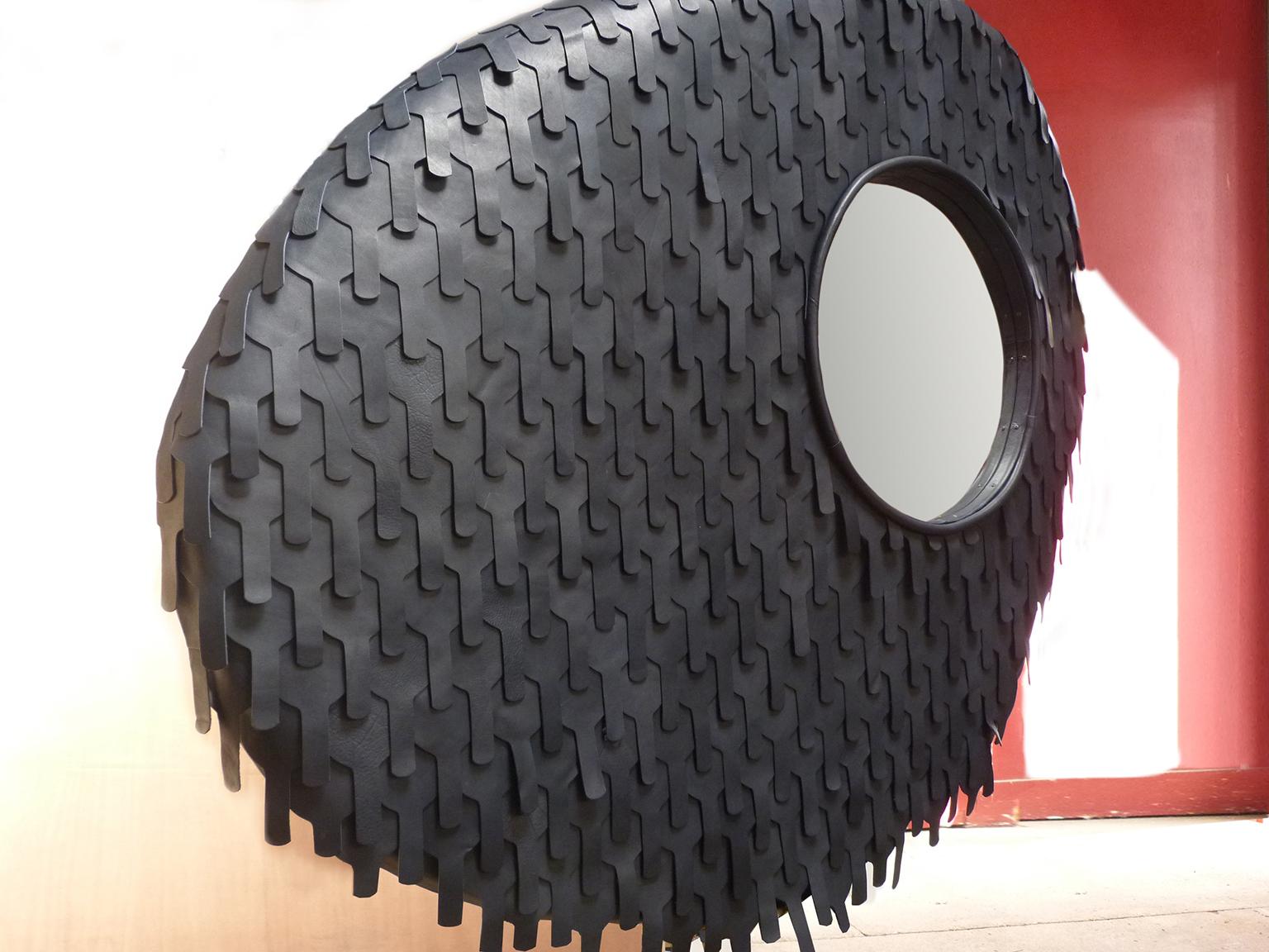 Organic modern artist creation one of a kind carved mirror, dressed in leather. Color: Black 
acrylic resin structure.
Measures: heigh 115cm/42.27i x width 130cm/51.18i. And depth 12 and 5 cm.