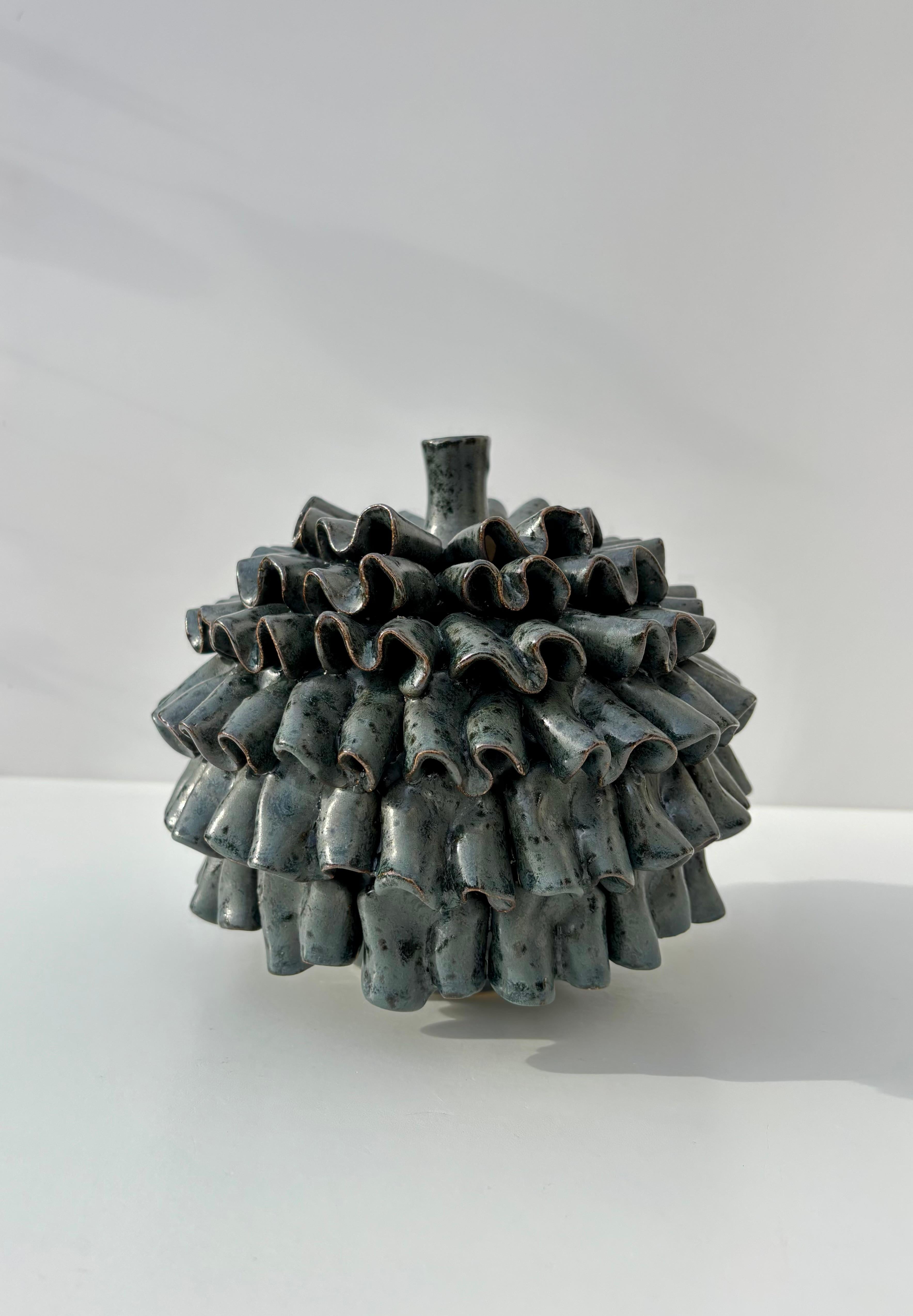 Organic modern ceramic vase with asymmetrical soft waves around the circular body. Spotted warm gray glaze with a blue tint. Beautiful condition.