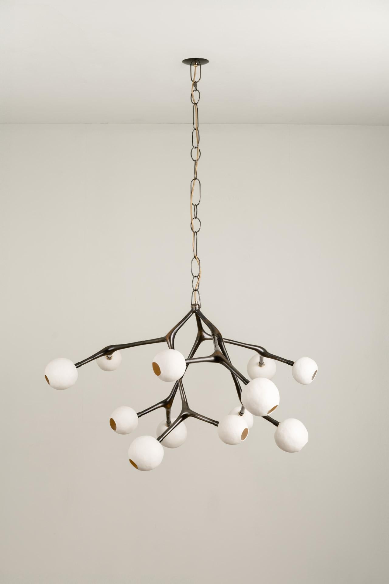 MARATUS chandelier was designed for the Mol collection by Mexican artist Isabel Moncada.

Maratus gets its name from a spider that displays an extravagant peacock-like tail to hypnotize prey with its mesmerizing pattern. In a subtly disorganized