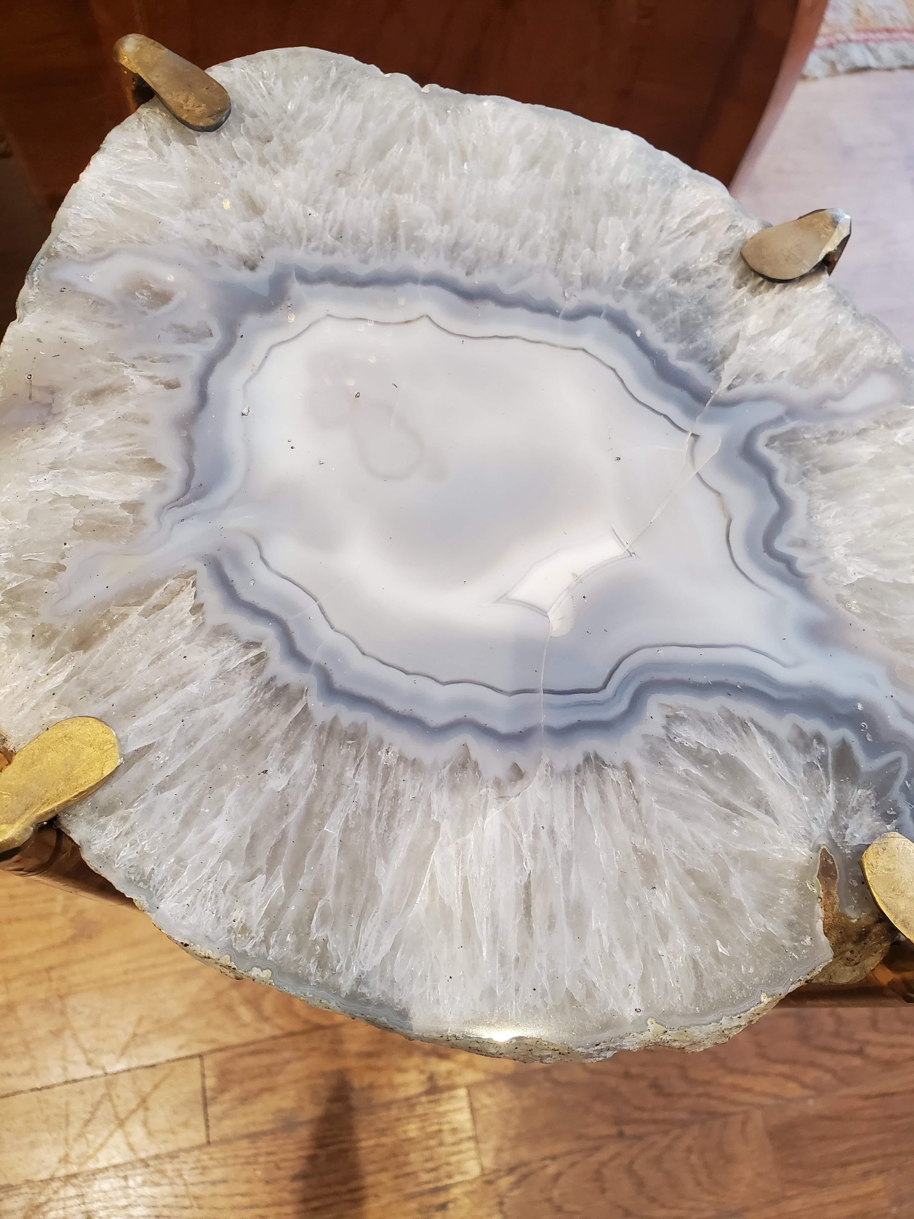 Our gorgeous geode drinks table is a perfect addition to any sitting room especially in an area where the sun hits them just right. Geode color on this table has defined clear crystal lines surrounding blueish gray and milky light gray