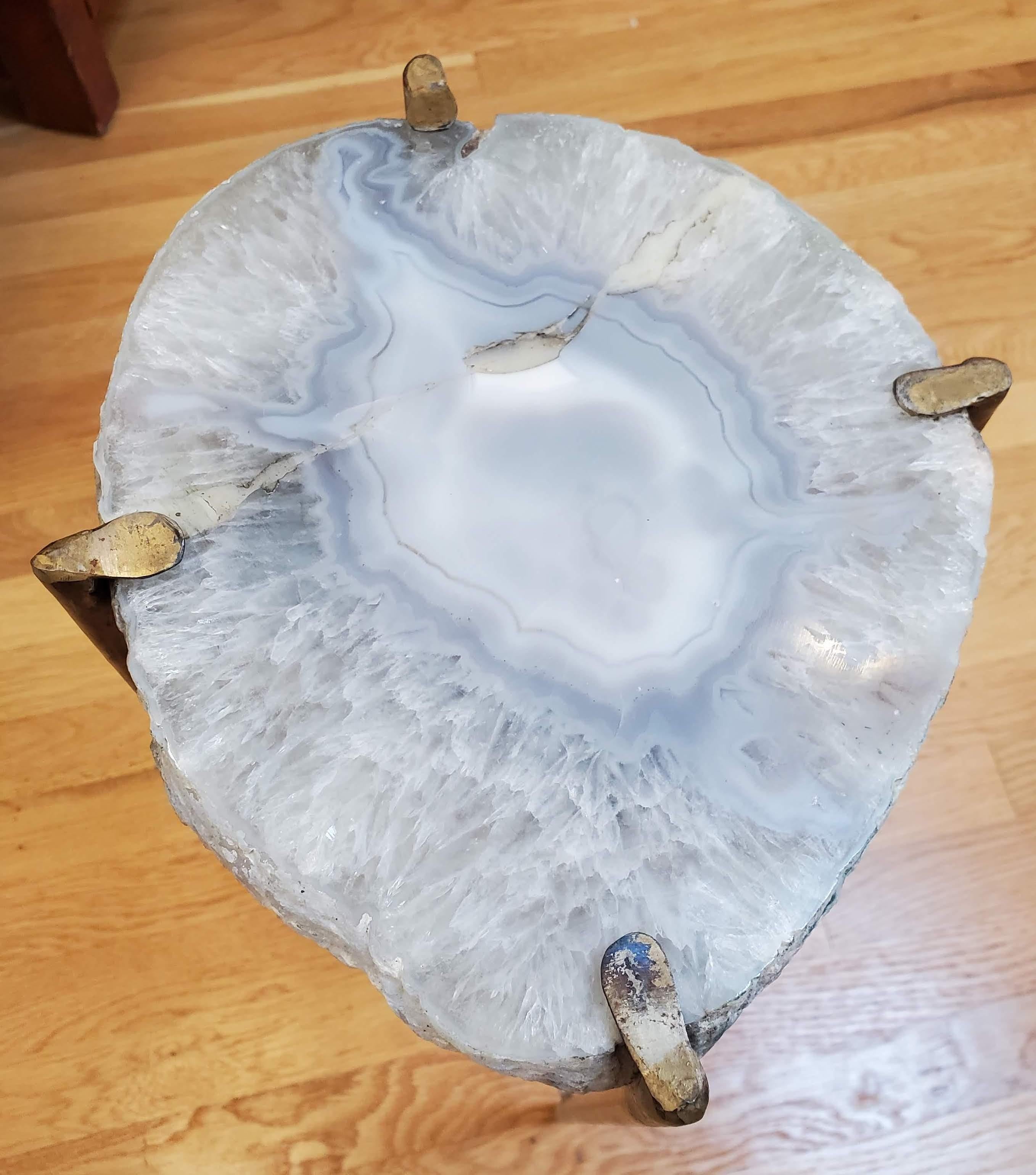 Our gorgeous geode drinks table is a perfect addition to any sitting room especially in an area where the sun hits them just right. Handcrafted with one of a kind geode slabs and gold gilt metal. this table is available as pictured or can be