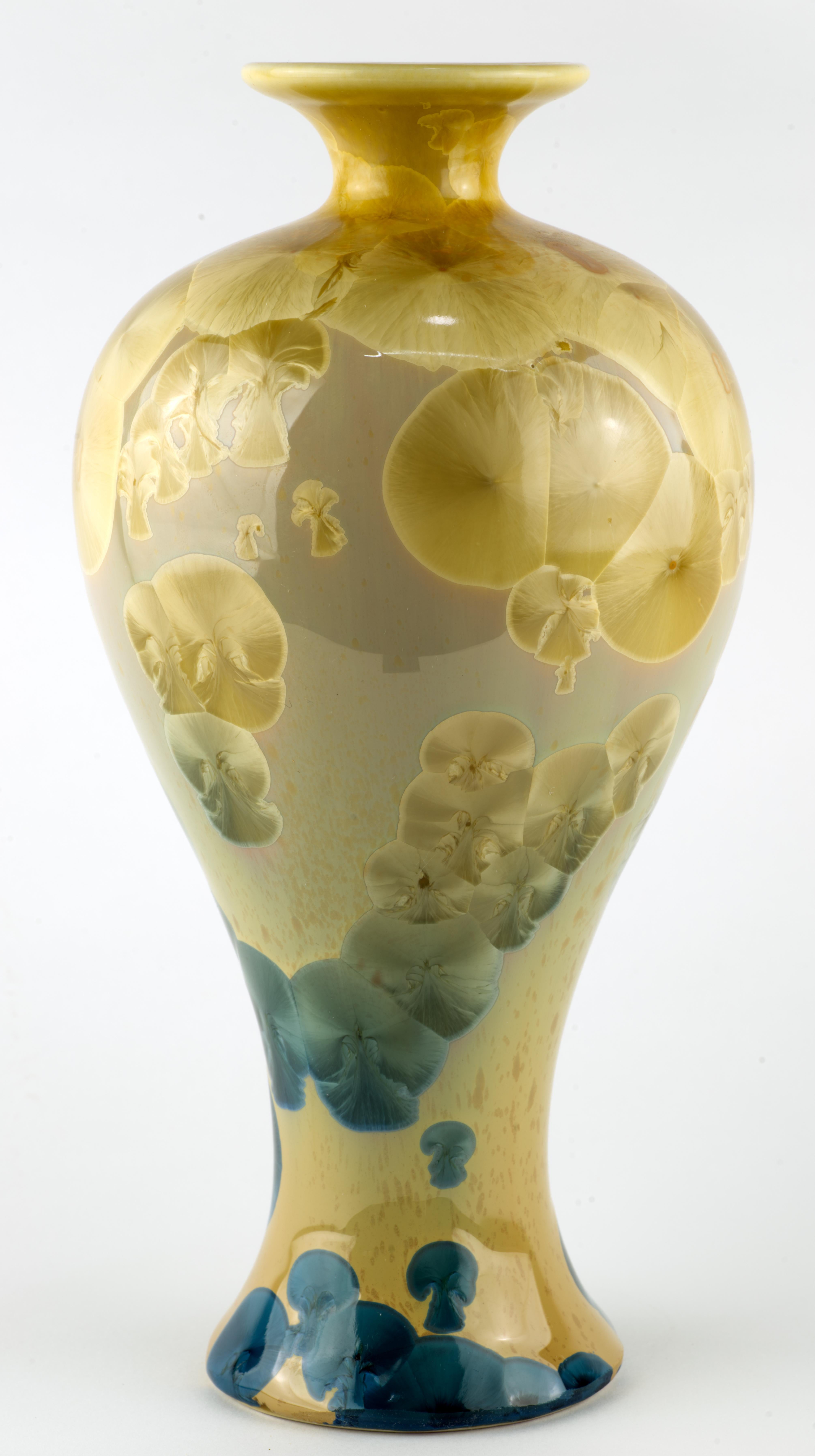  Medium sized porcelain vase is decorated with crystalline glaze in organic, natural tones. Deep blue and warm beige crystals on ombre light beige and pale blue background were grown in a kiln during a very long, controlled firing. Each crystalline