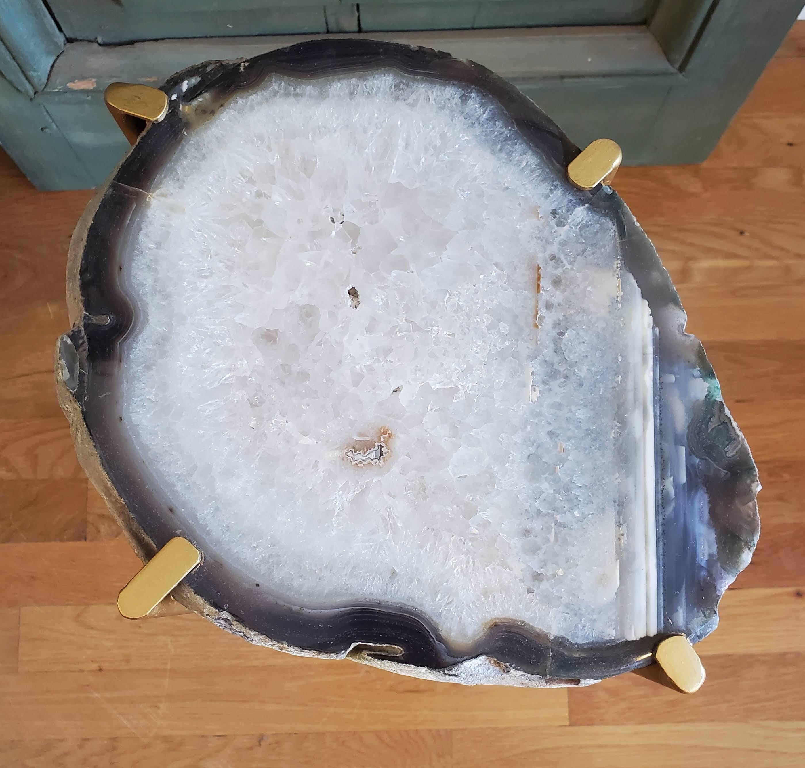Our gorgeous geode drink tables are a perfect addition to any sitting room especially in an area where the sun hits them just right. Handcrafted with one of a kind quartzite slabs and gold gilt metal, this table is available as pictured or can be