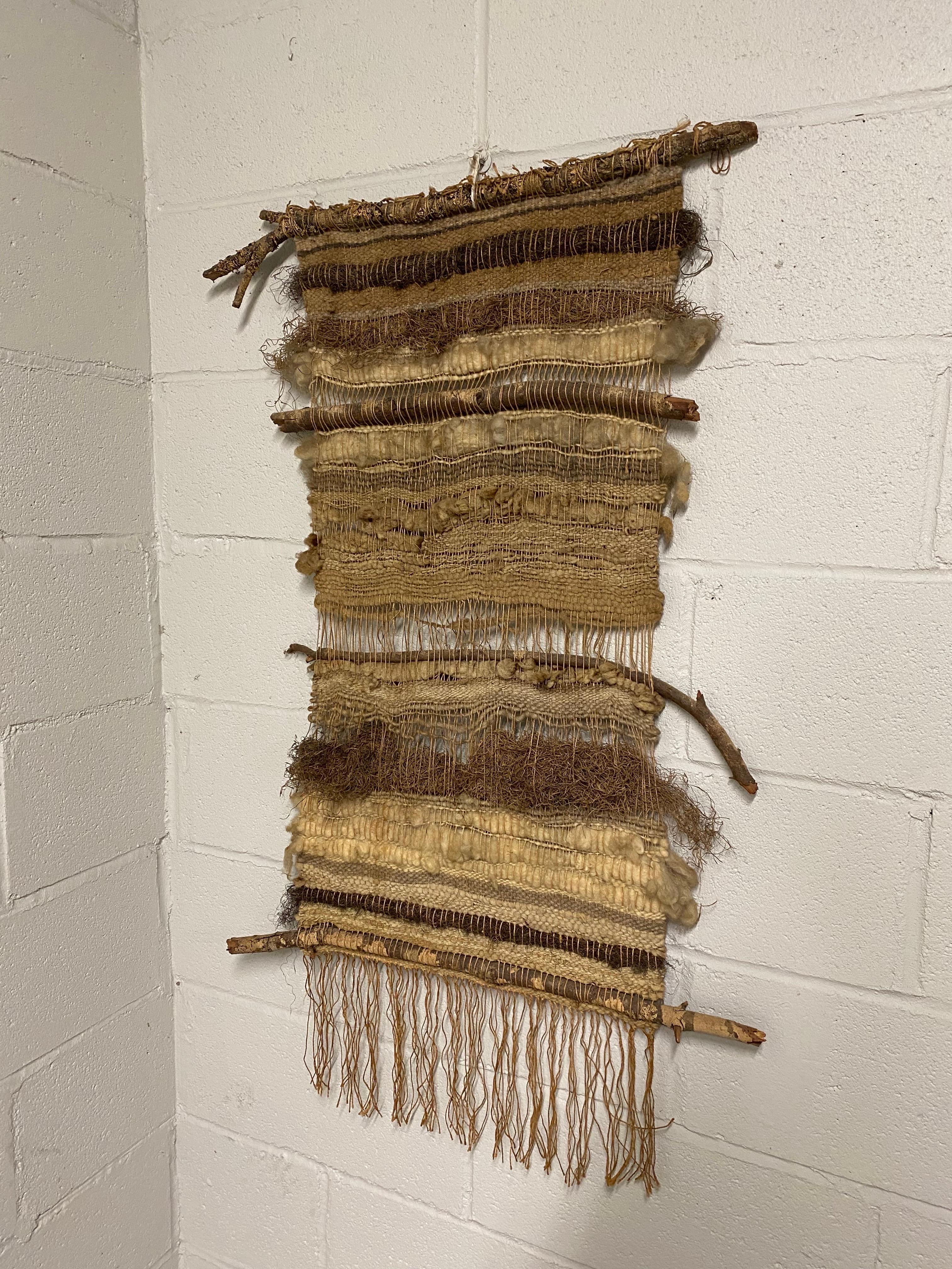A fine fiber art wall hanging made of wool, cotton, wood and natural fibers. Organic Modern crafts at its finest. Made at the height of hand crafted decorative wares in the late 1960s and early 1970s. This piece was made by a local Woodstock artisan