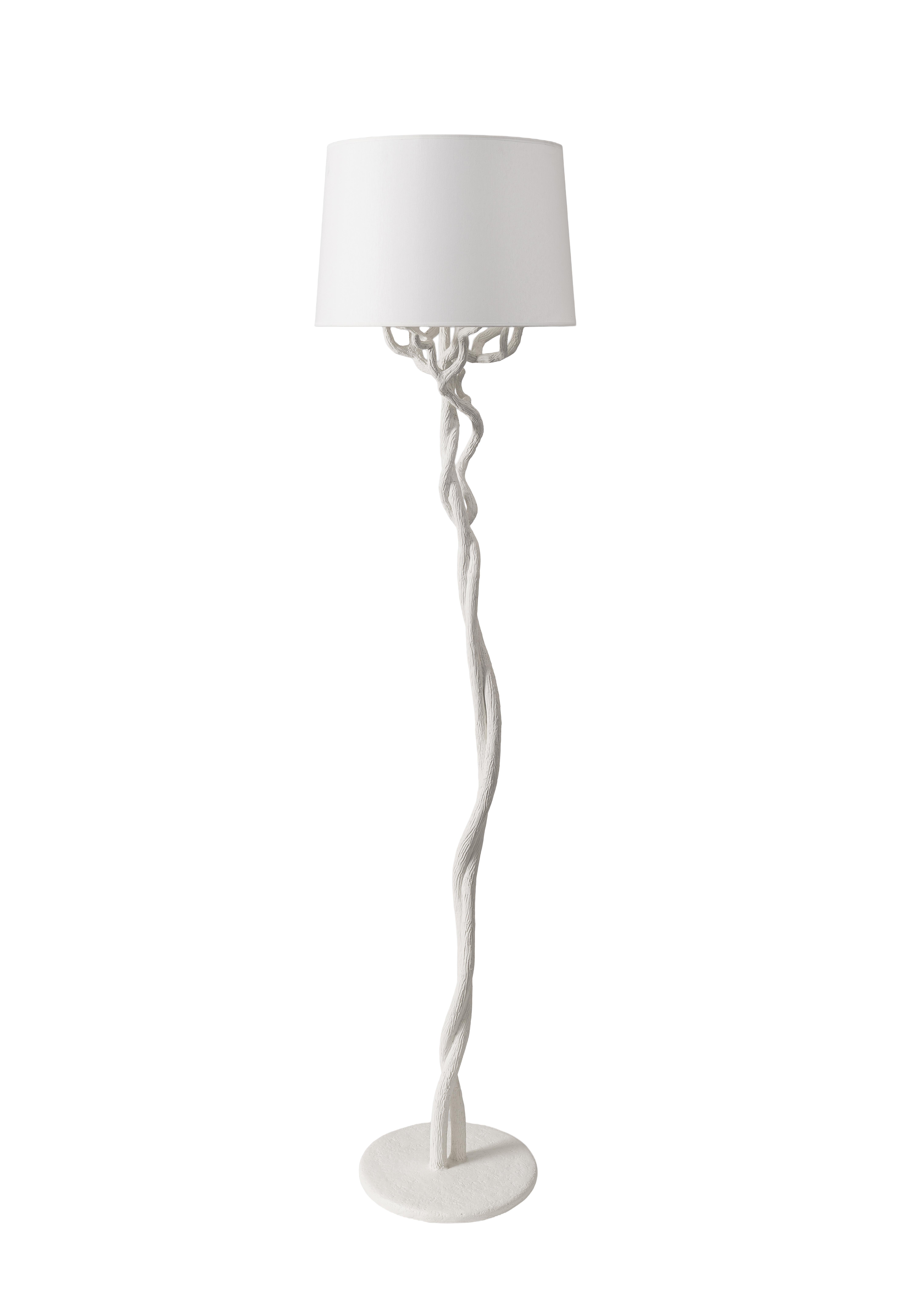 The Fioli tree branch floor lamp is individually hammered and hand formed. Each piece has been skillfully finished in plaster to resemble the texture of tree bark. Available in Bronze Plaster Finish and White Plaster. This lamp is not just a source