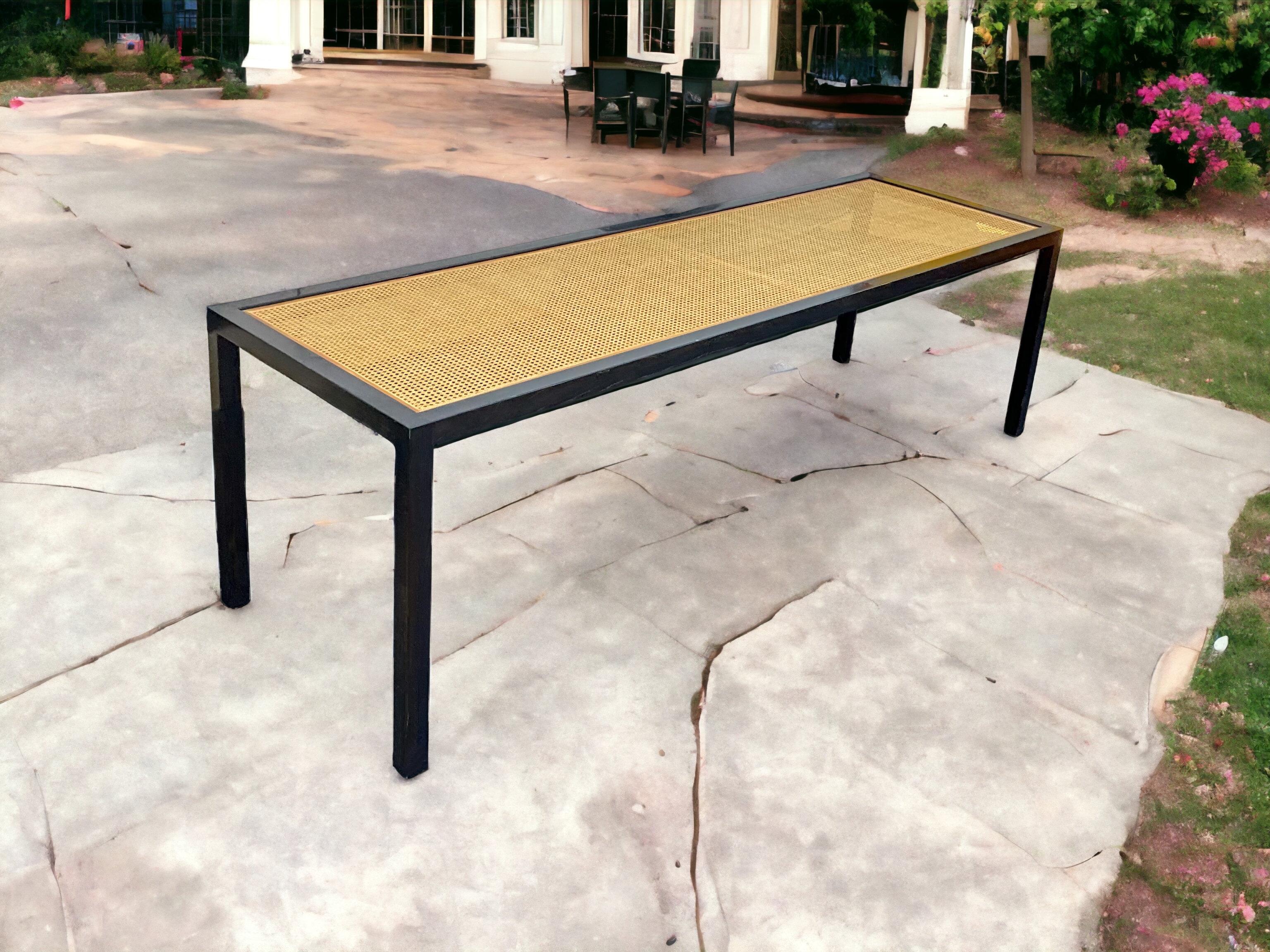 This is such an interesting table. It is in the manner of Danny Ho Fong with its cane top and slender Parsons’ style form. The ebonized frame is in very good condition. The glass top was removed for photography. It could work as a dining table or