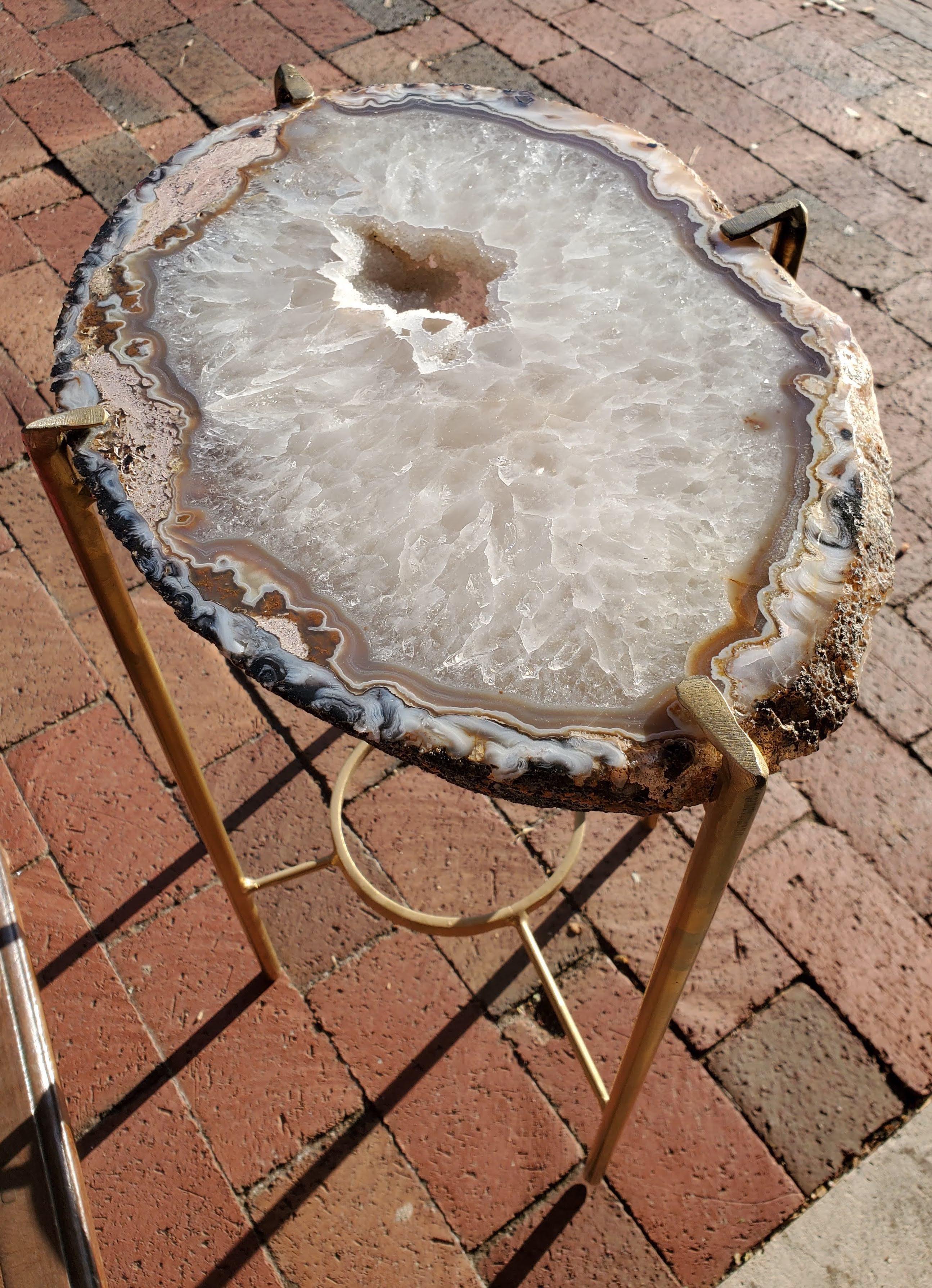Our gorgeous geode drinks table is a perfect addition to any sitting room especially in an area where the sun hits them just right. Handcrafted with one of a kind quartz slabs and gold gilt metal, this table is available as pictured or can be