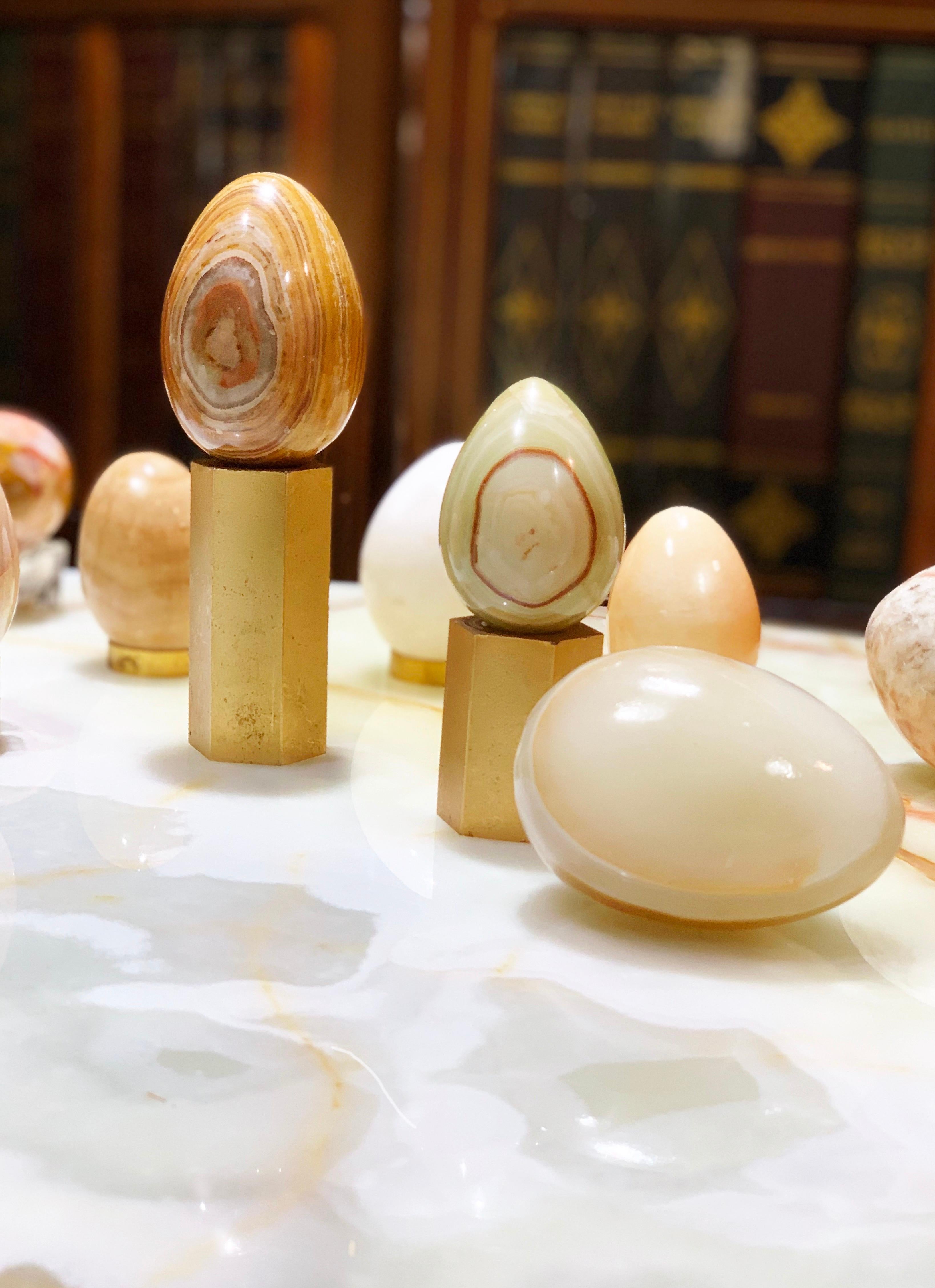 Organic modern hand carved stone egg sculptural set with Heavy guilt brass bases. Gorgeous three egg set, veined to perfection by Mother Nature and hand-burnished by mid-century artisans. 2 Hexagonal solid gilt brass bases included with three eggs