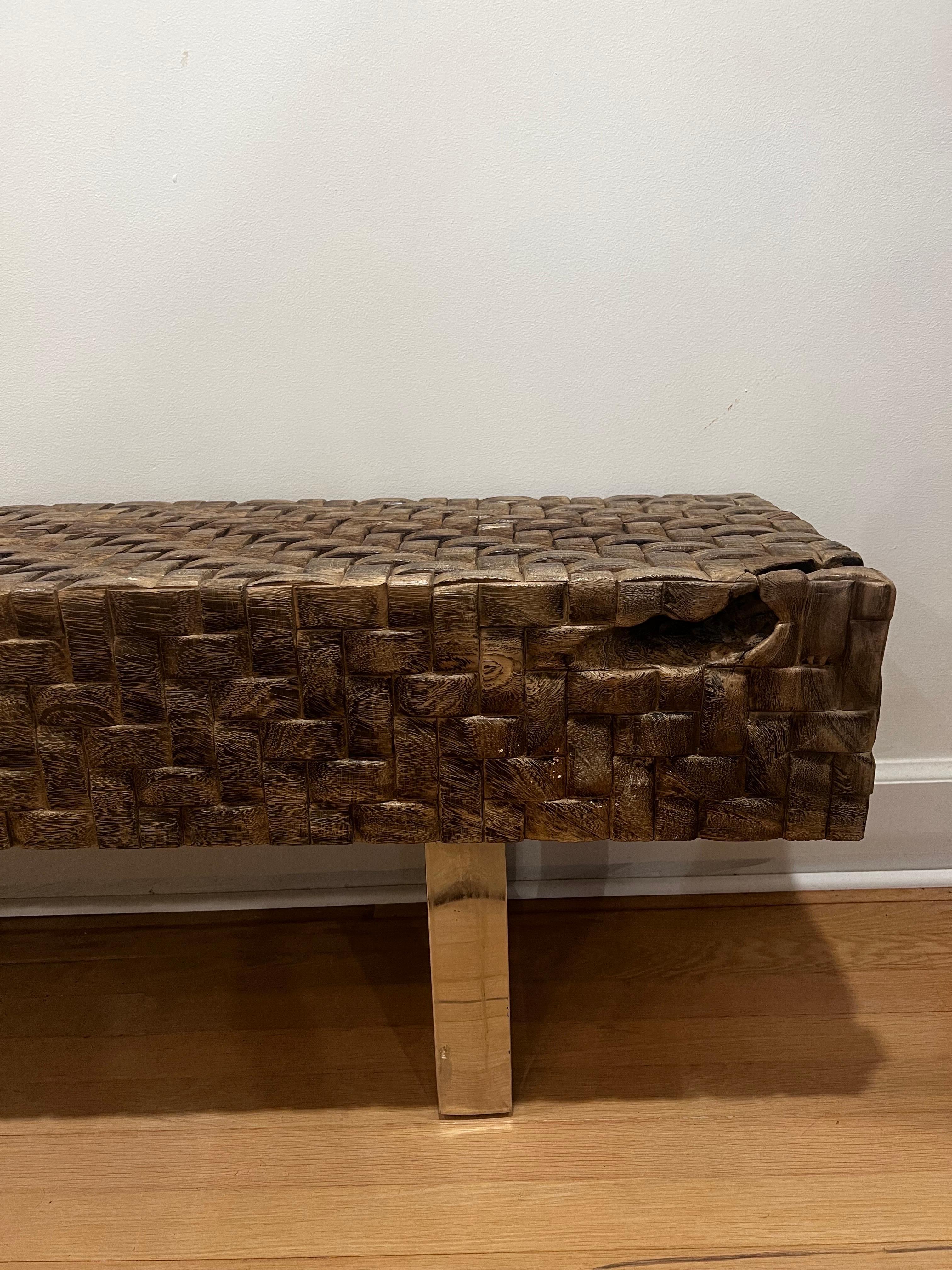 Hand crafted carved wood low profile bench with solid steel base.  
Modern/contemporary style.  

One large log carved with a unique weave pattern.   

