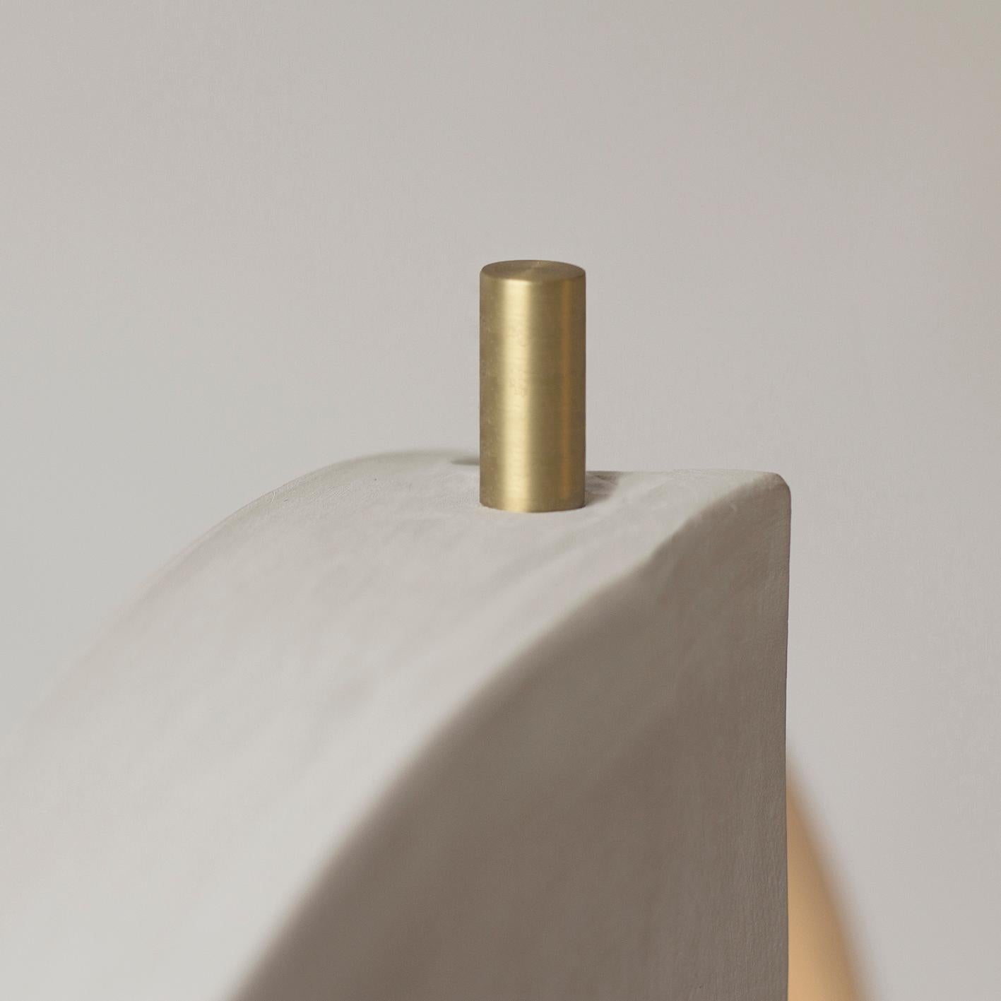 Minimalist-styled sand ceramic table lamp reveals the textures and colors gradian of its materials, handmade movements, and unexpected organic form.
Slowly air-dried for more than 30 days, until it reaches a few hours into a low temperature hoven,