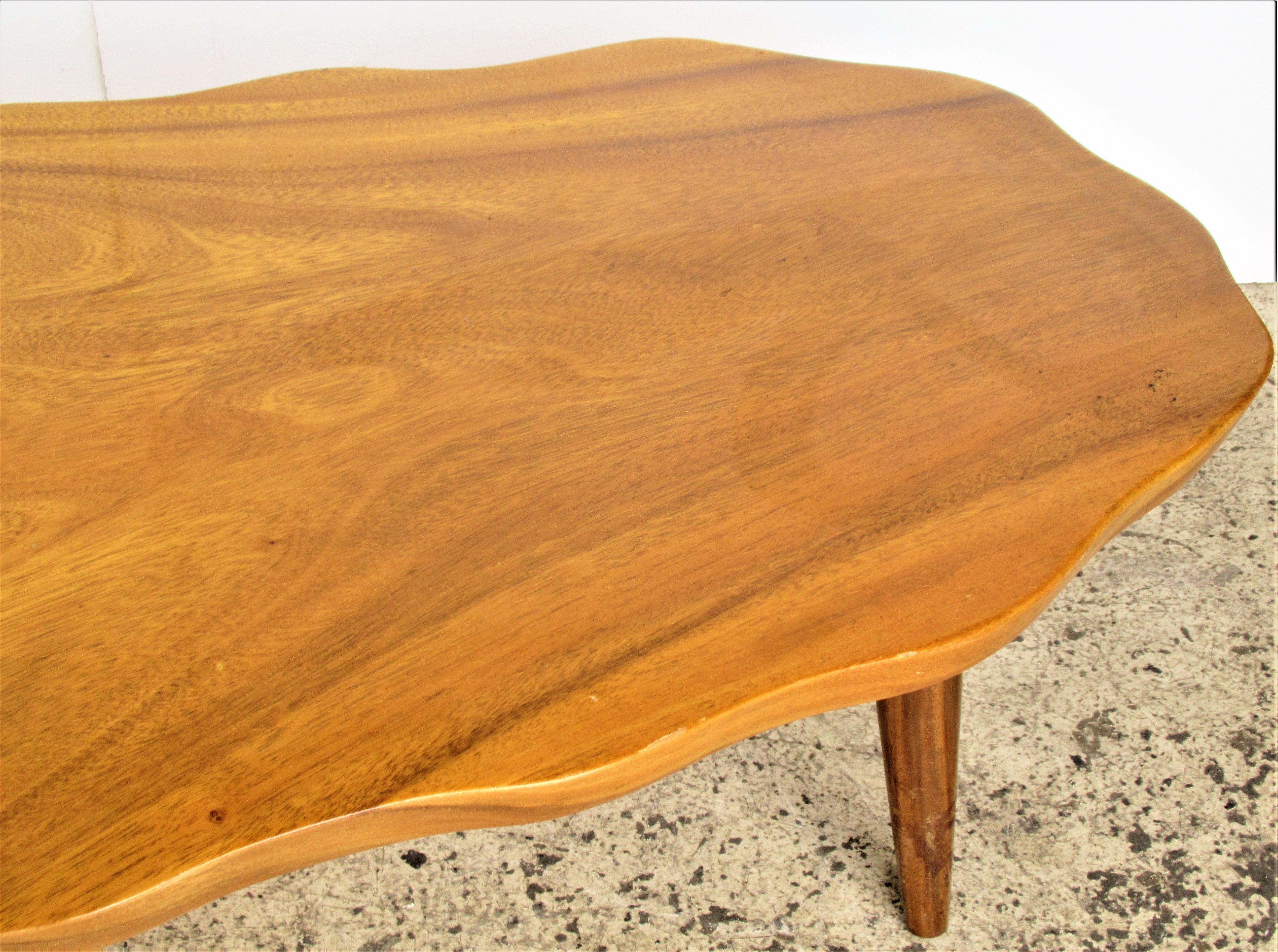 1960's organic modern monkey pod wood coffee table with biomorphic form and original glowing surface to the beautifully grained wood. Stamped on underside - made in Honolulu, Hawaii by Harry's Cabinet & Curio Shop.