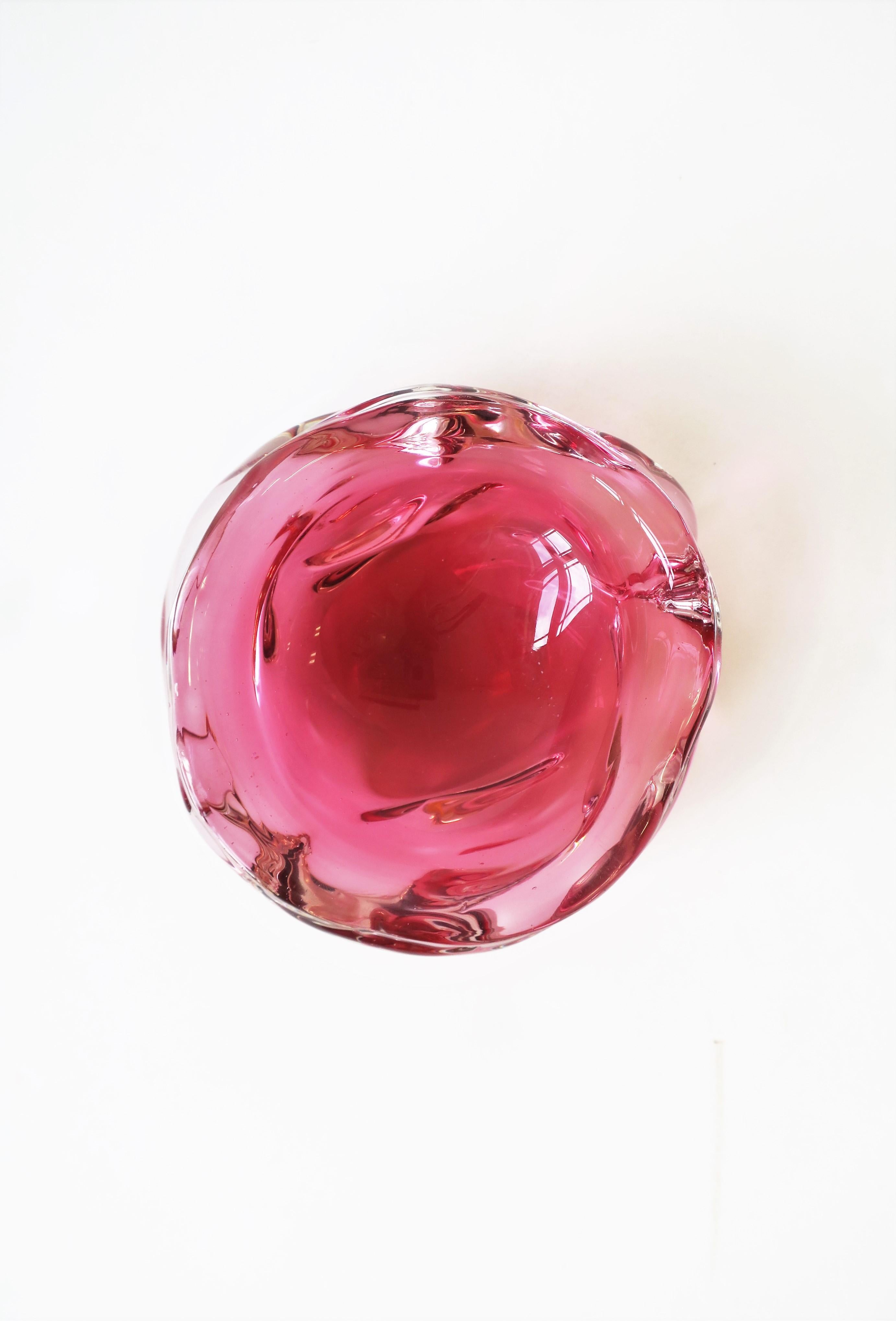 A beautiful and substantial Italian Murano bowl made in a red raspberry/deep pink and clear art glass, with soft edges in an organic modern form/style, circa mid-20th century, Italy. Bowl measures: 1.88
