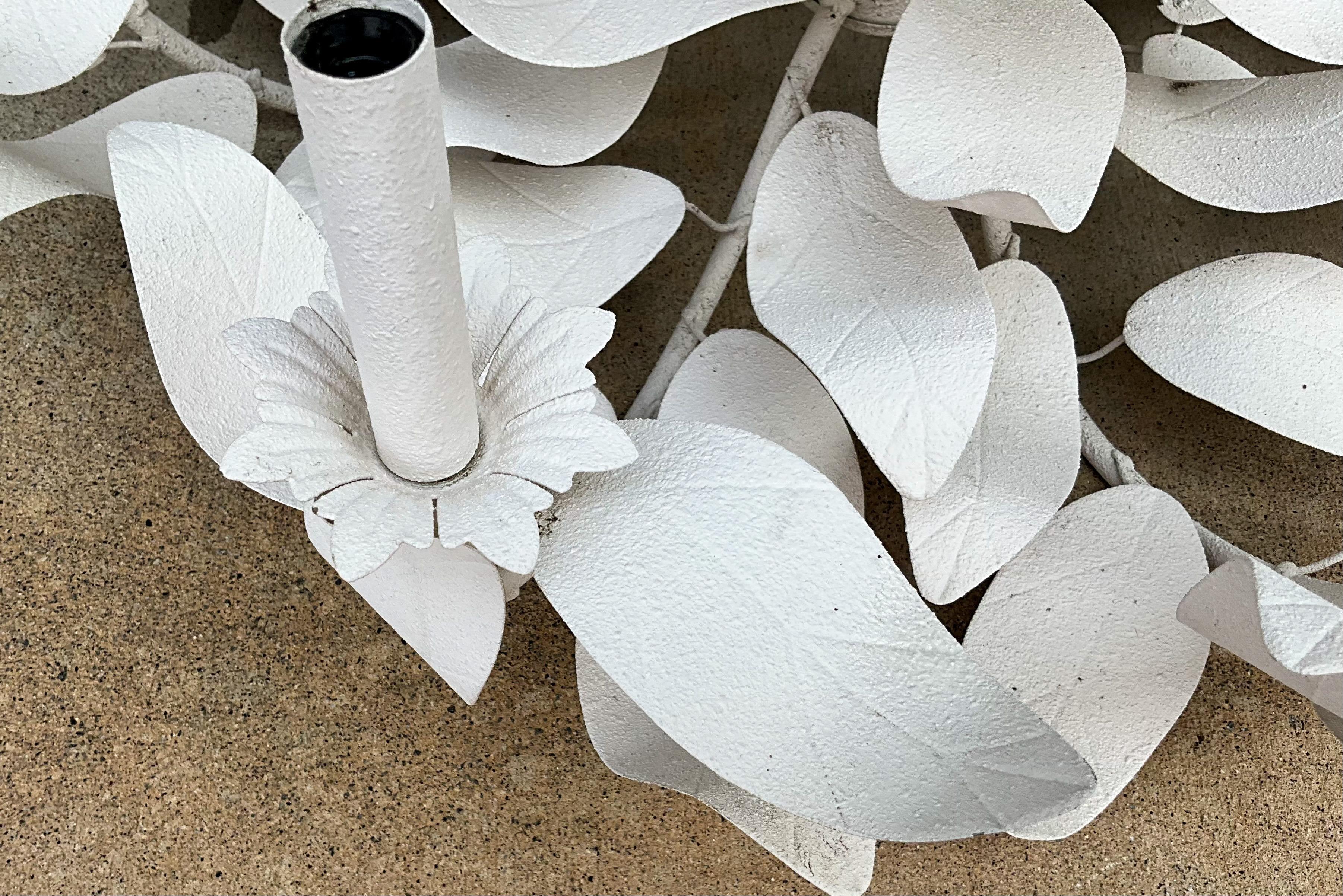 This is fabulous! It is a Modern interpretation of the traditional tole chandelier. It looks like wind blown leaves circling the stem. It is white, and the finish is original. There are 9 arms, and it has been examined by a lighting professional.