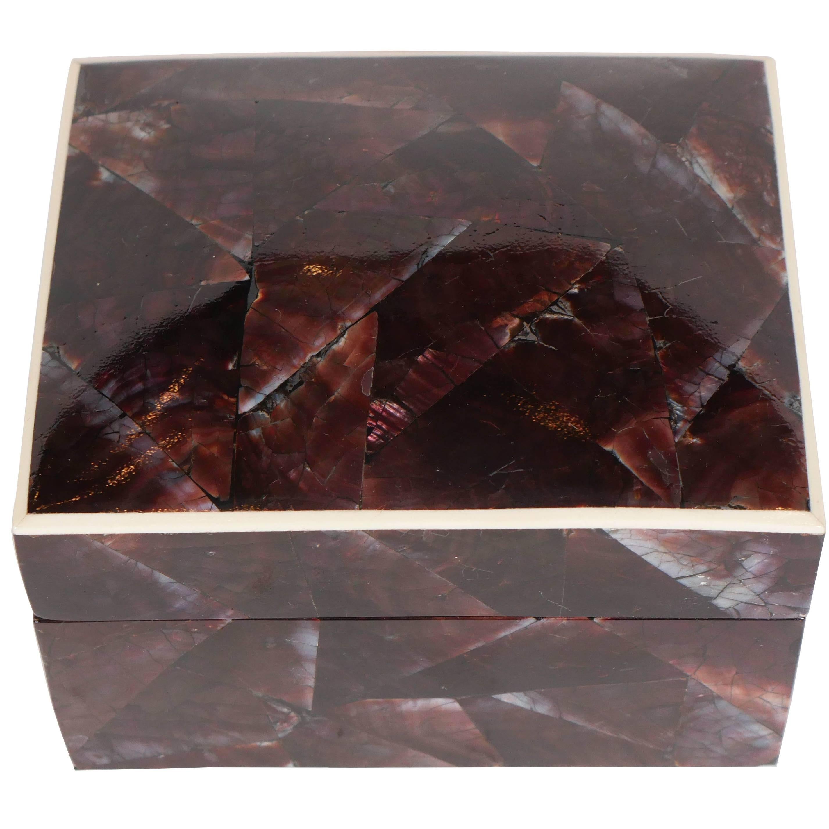 Elegant decorative box or jewelry box comprised of natural pen shell. The luminous iridescent shells have a mosaic pattern in hues of brown and aubergine. Lid features a contrasting exotic bone trim and opens to reveal a palm wood interior. All