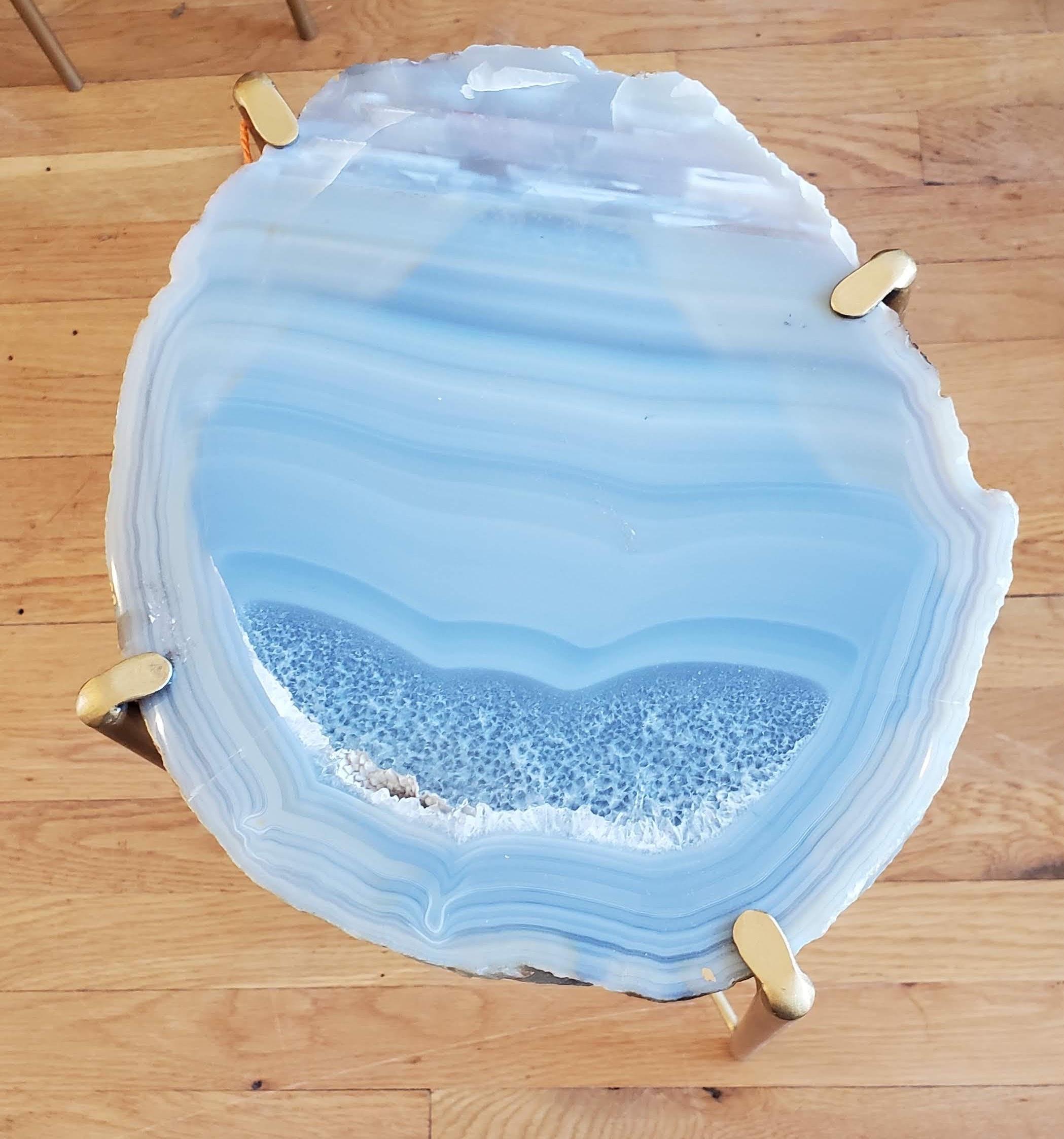 Our gorgeous geode drink tables are a perfect addition to any sitting room especially in an area where the sun hits them just right. Handcrafted with one of a kind quartzite slabs and gold gilt metal, this table is available as pictured or can be