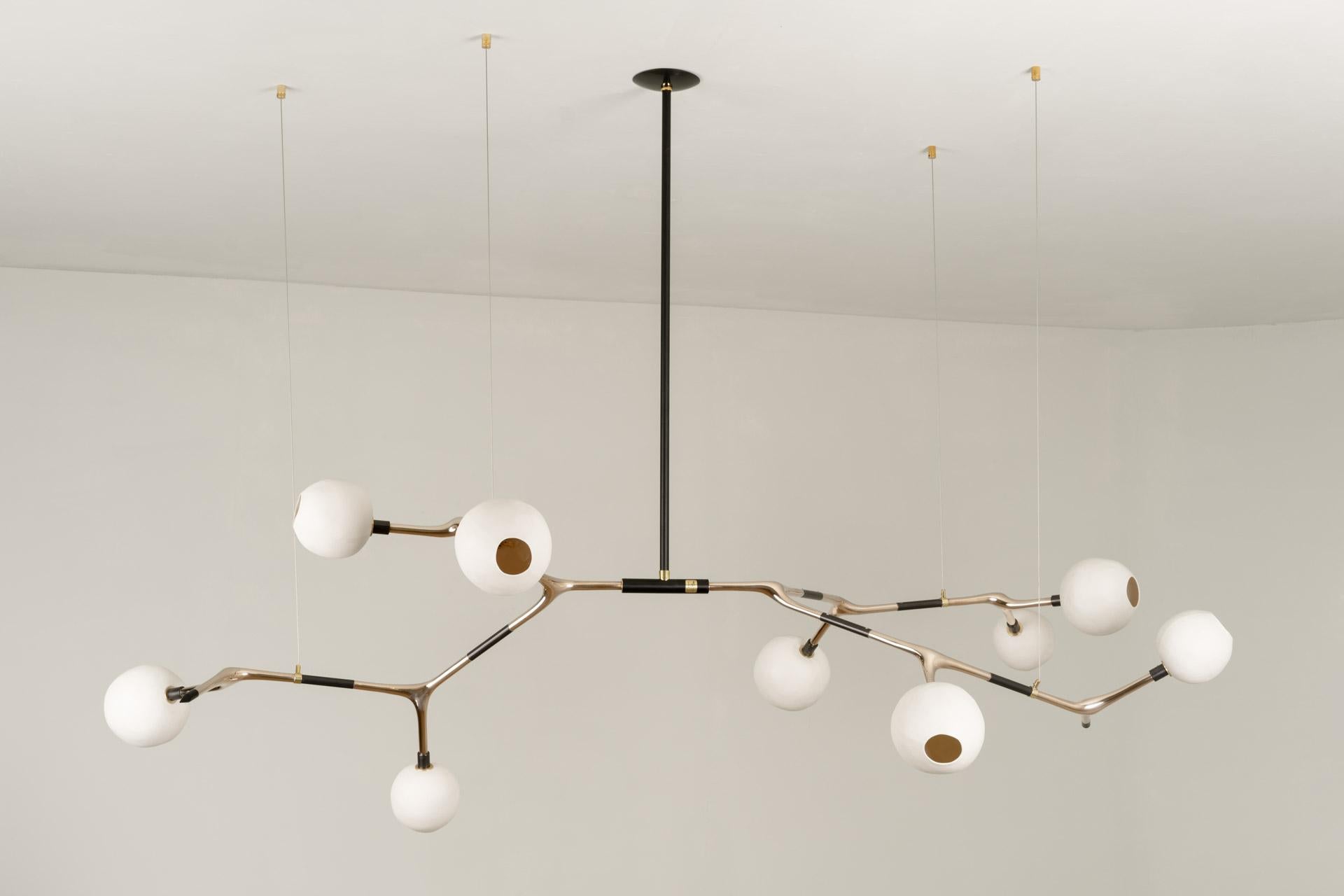 MANTIS 9 pendant light was designed for the Mol collection by Mexican artist Isabel Moncada.

Mantis 9, discreet and elegant with measured dimensions. For a medium and sober table, the Mantis 9 is the key element in a reception area, a living room