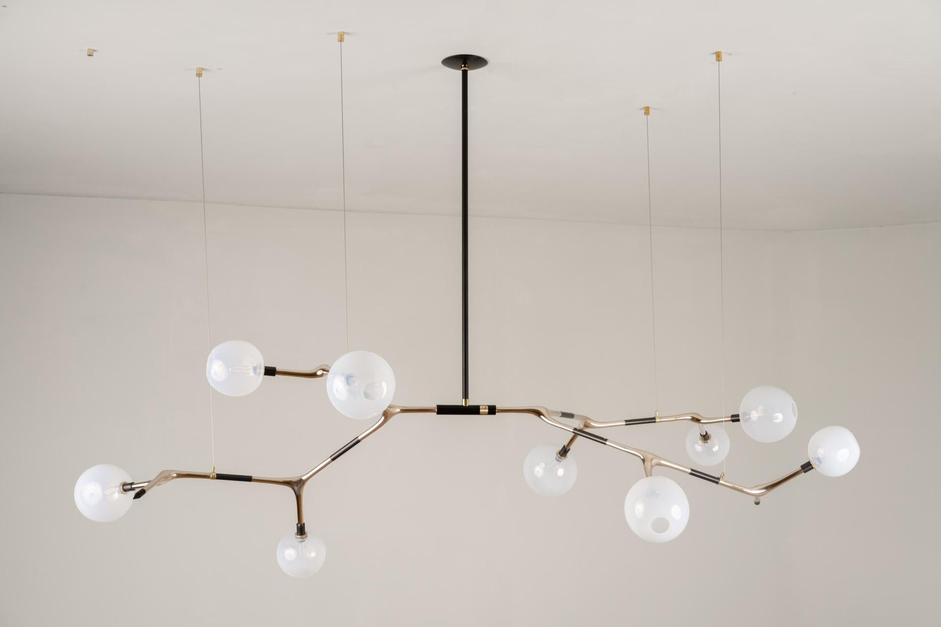 MANTIS 9 pendant light was designed for the Mol collection by Mexican artist Isabel Moncada.

Mantis 9, discreet and elegant with measured dimensions. For a medium and sober table, the Mantis 9 is the key element in a reception area, a living room