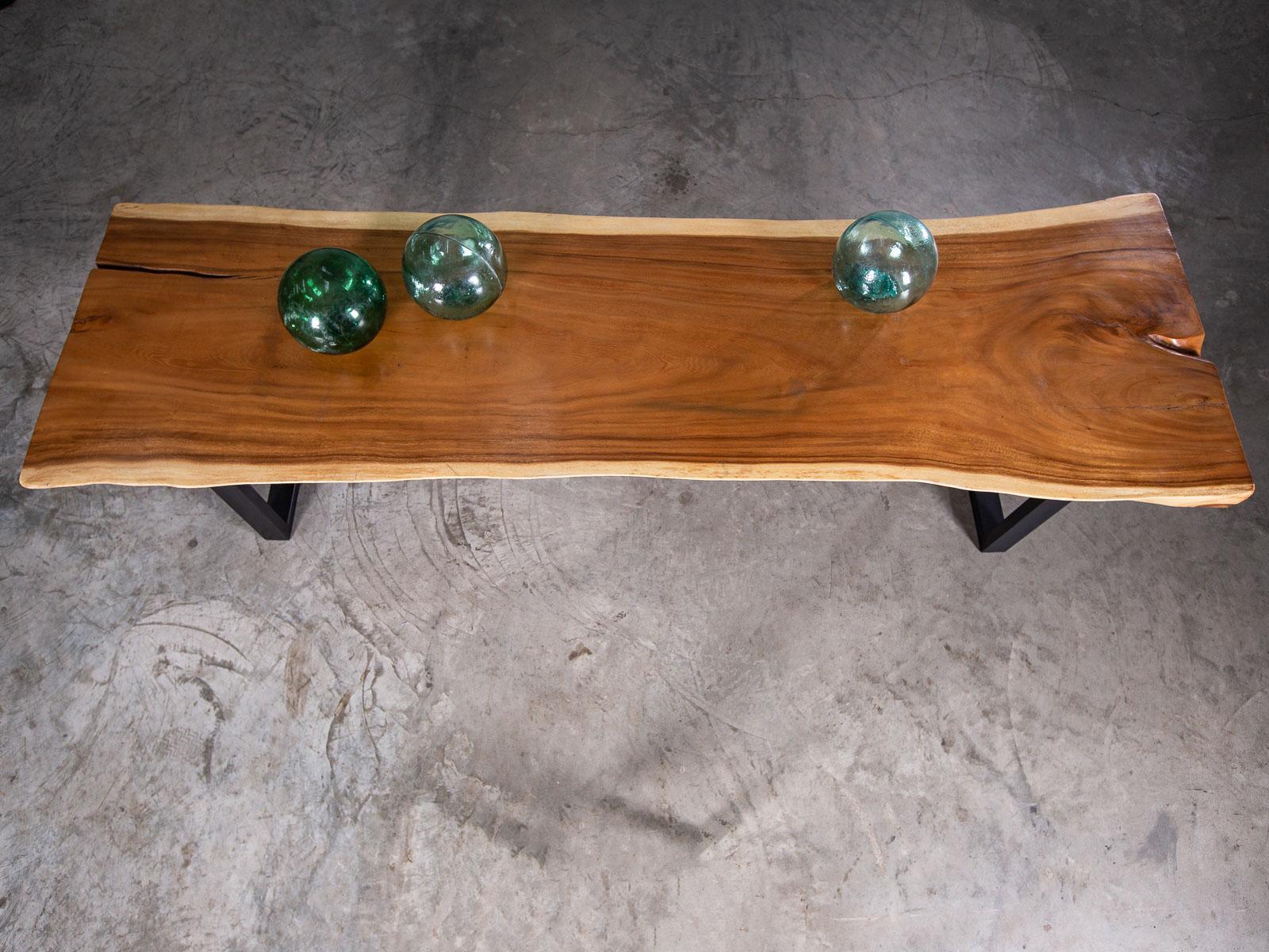 This unique organic modern live edge teak contemporary dining table has been created from a single one of a kind slab of timber and mounted on a clean line metal base. Please enlarge the photographs to see the striking grain of the timber and its