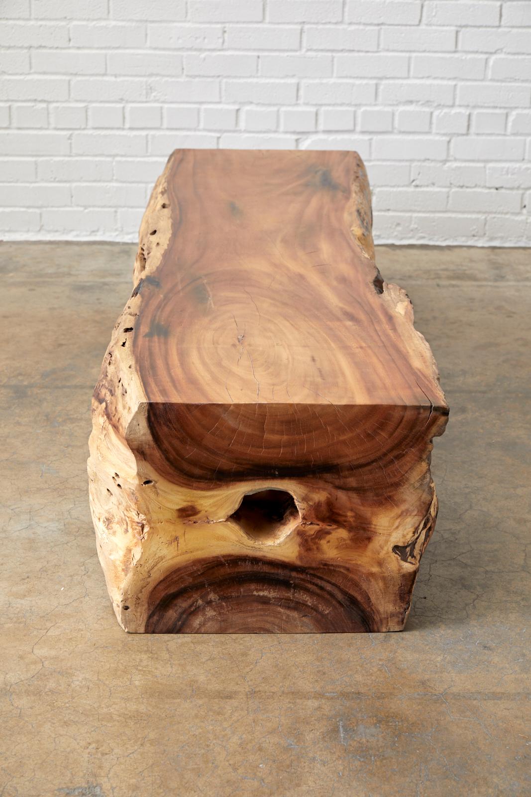 Fantastic organic modern live-edge teak hardwood log bench made from a massive timber. Gorgeous from any angle this bench showcases the weathered outer bark and the radiant grain patterns of the wood. Very heavy and solid from an estate in Malibu,