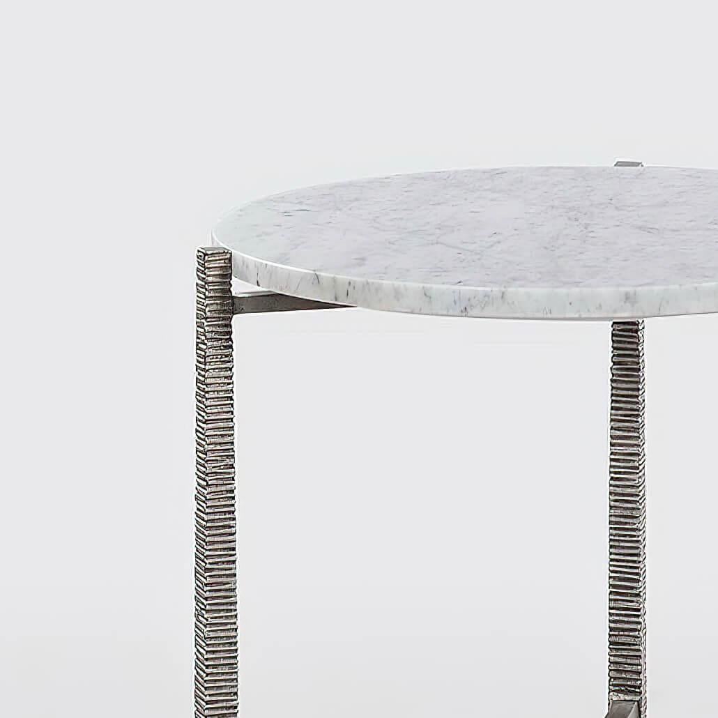 Organic modern round lip side table with three cast textured aluminum legs and smooth stretcher, with has a “silver” finish on the base and a “Carrara” marble top.

Dimensions: 20