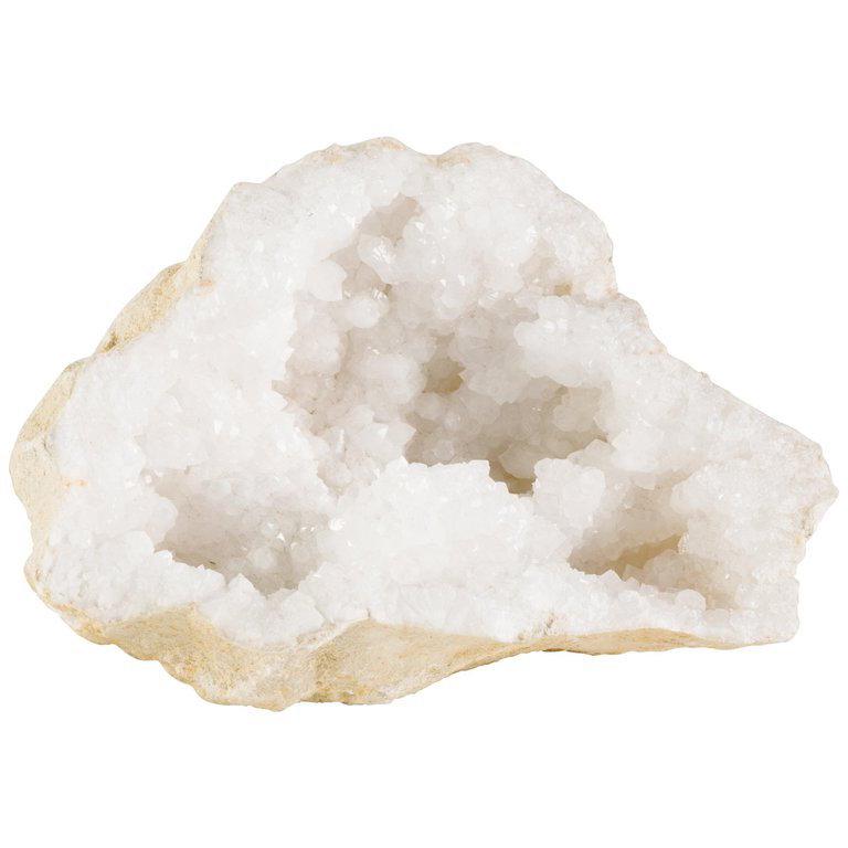 Exquisite large quartz crystal geode from Morocco. The white rock crystal specimen features both Fine and chunky quartz crystals throughout and has a stunning stone exterior in hues of sand and beige. Gorgeous natural sculpture adding organic modern