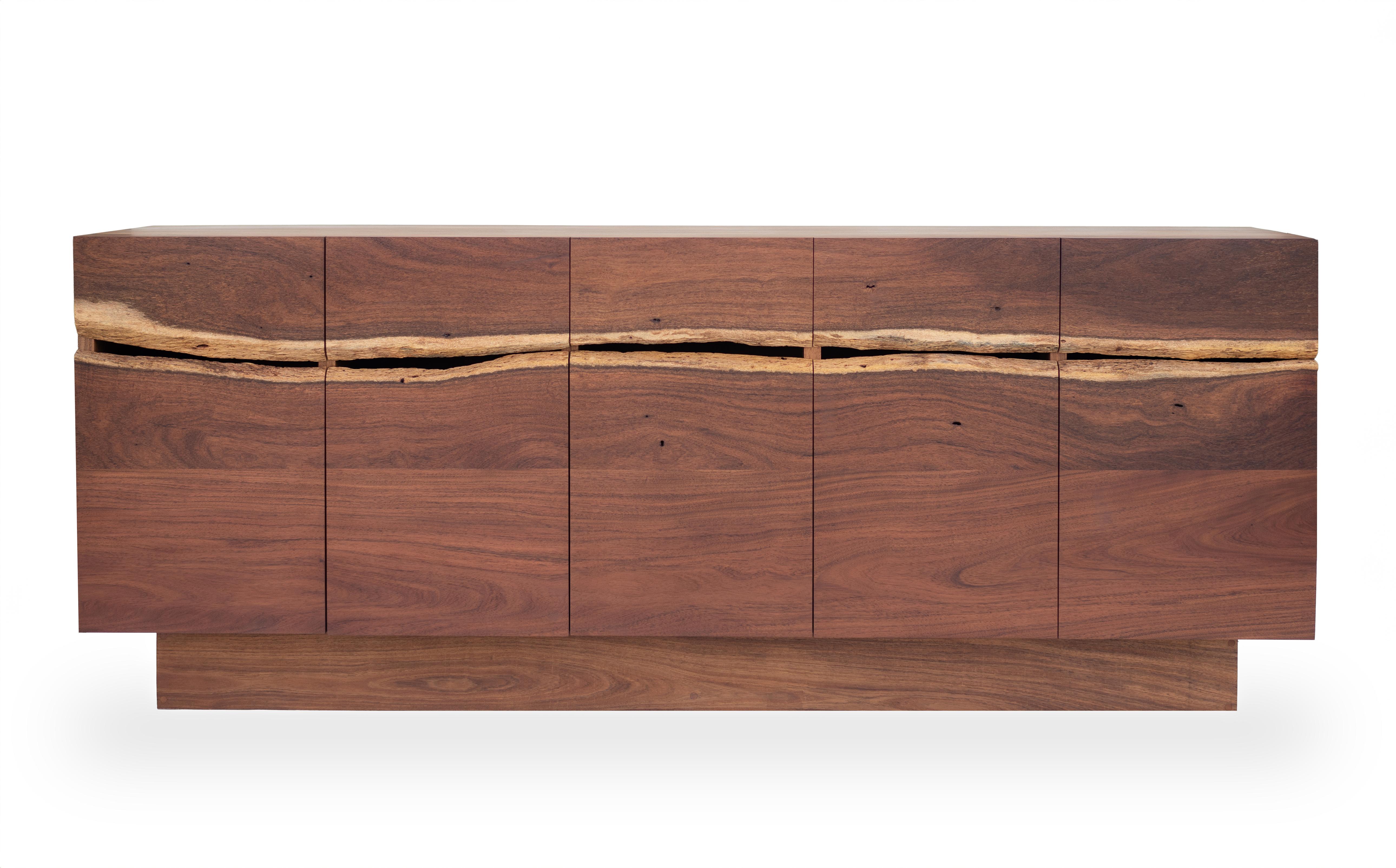 A credenza with a front crafted from two planks with natural edges of Caribbean Walnut wood. 
The design of this piece aims to highlight the beauty of tropical wood in its natural state, with extraordinary organic aspects crafted with the utmost