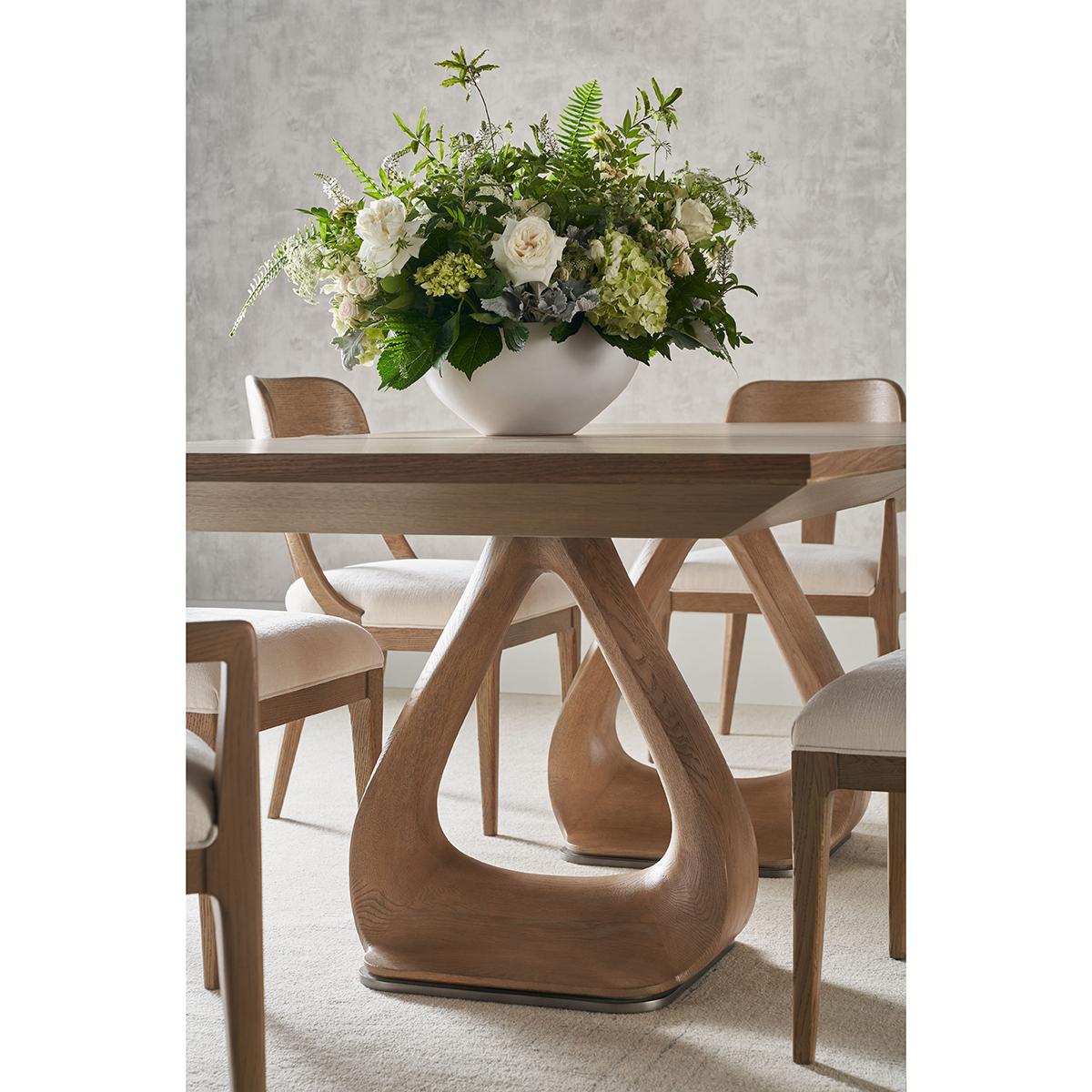 Masterfully crafted from oak, and finished in light blonde finish, this table showcases the natural beauty of the wood through its gentle, soft lines and a knife-edge top, creating a sophisticated and inviting atmosphere.

Featuring a unique shaped