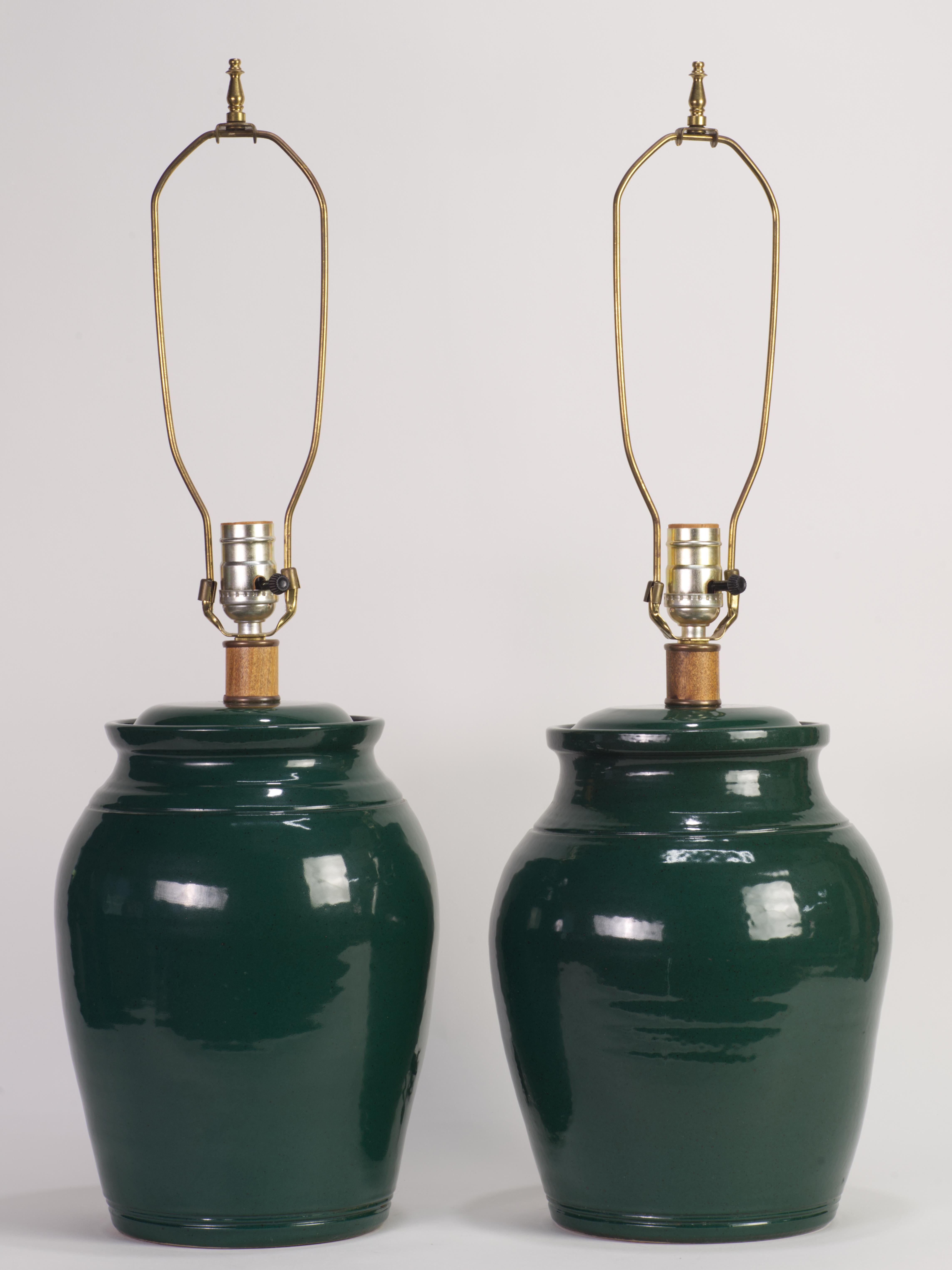  The vintage studio art pottery drum-shaped ceramic table lamps are hand thrown in coil technique, with slight variations in lamps' curvature and body diameter that emphasize the handmade nature of the pieces. The distinct, minimal design is