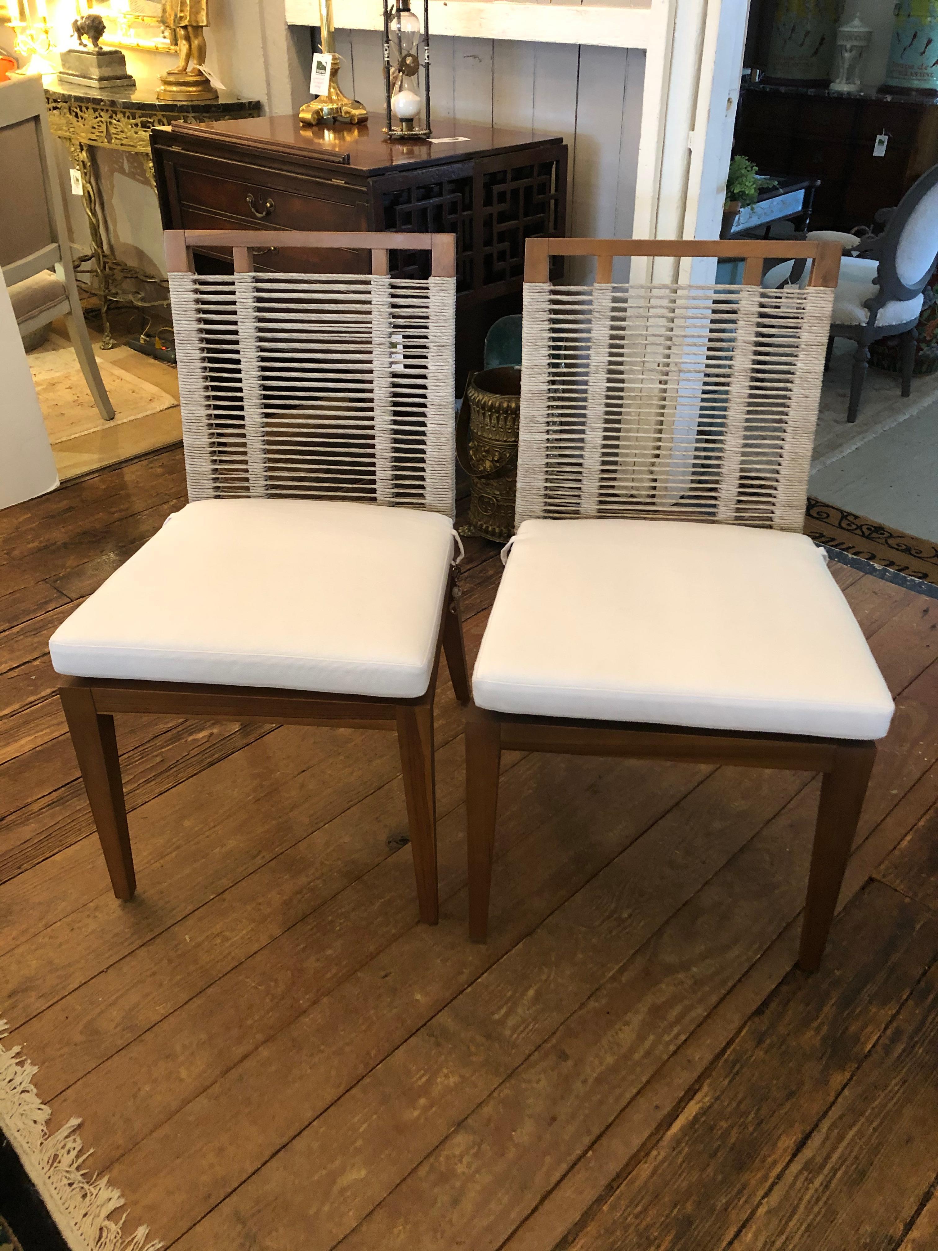 Beautifully made pair of contemporary side chairs having raffia rope woven seats and raffia rope entwined backs that are very comfortable but airy and see through. Custom white duck cushions are included.
Great at the head of a dining