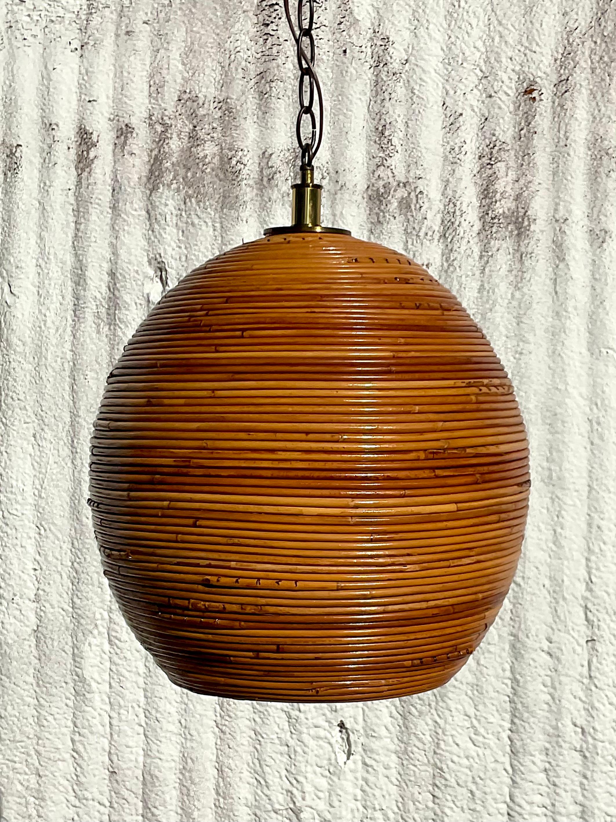 Fantastic organic modern hanging lamp. Beautiful coiled pencil reed in a chic hive shape. Minor scuffs and blemishes appropriate to its age and use. Acquired from a Palm Beach estate.