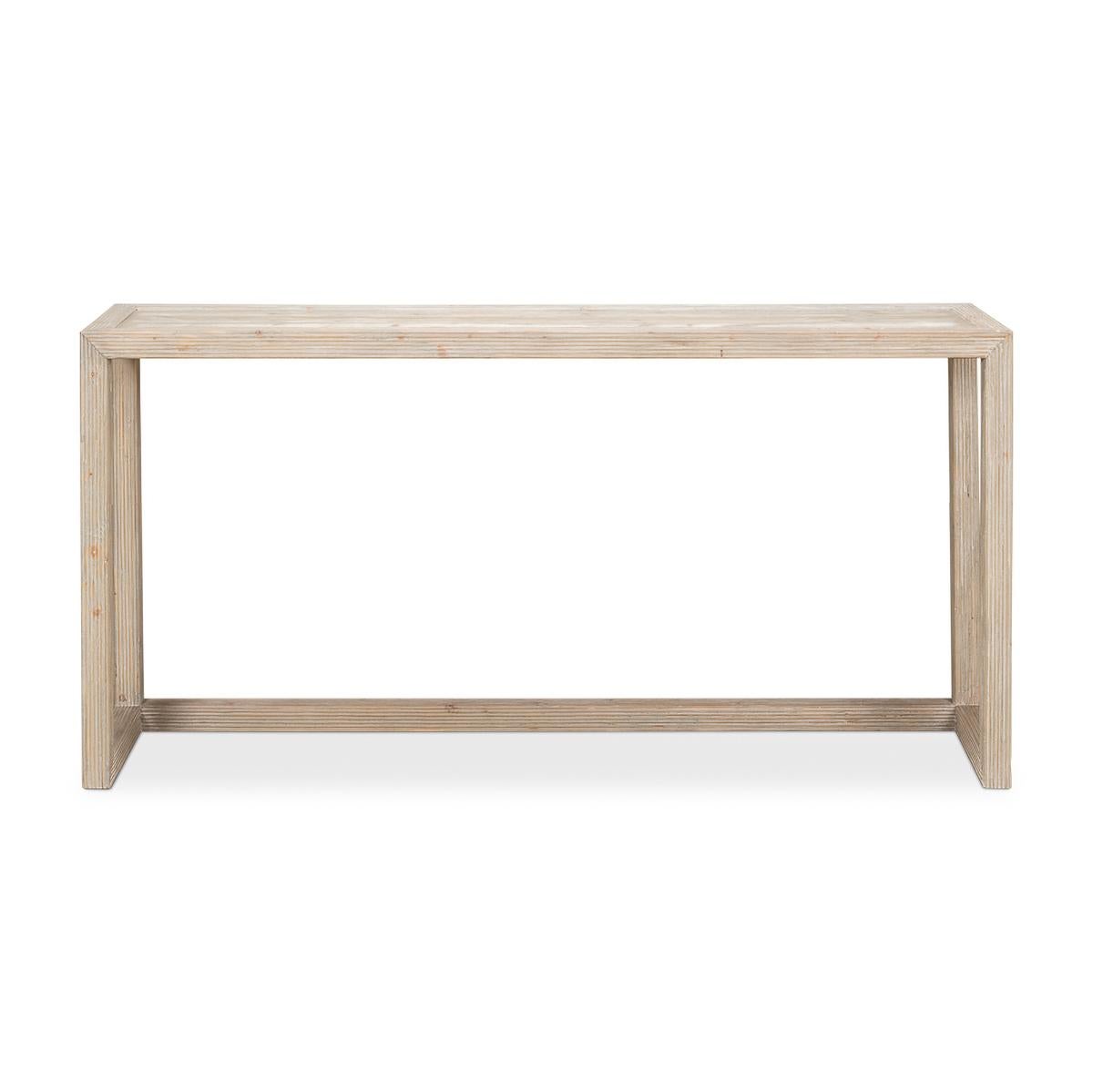 An Organic Modern pine console table with a pickled finish, a reeded framed edge, and a stretcher base.

Dimensions: 66
