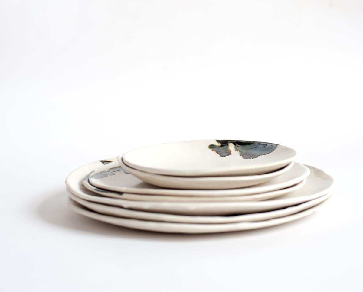 Porcelain and platinum dinner plates. Slab-formed, imperfectly-round dinner plates. Each plate is different, and looks great alone or as part of a set. Available in three different sizes.