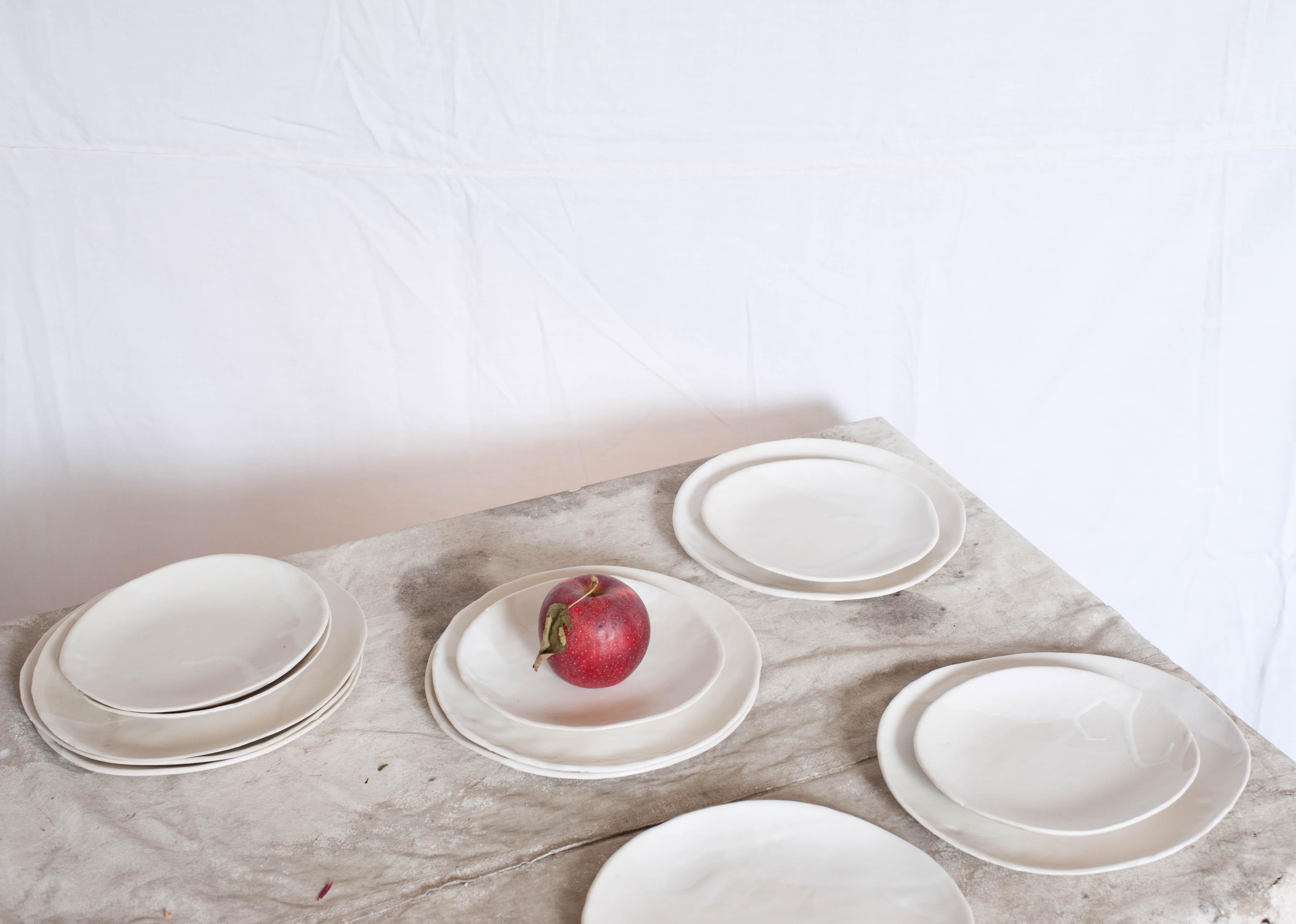 Layers of matte and glossy white glaze on slab-formed, imperfectly round, porcelain plates. Each plate is glazed differently, and looks great alone or as part of a set.

Approximate dimensions: 

Dinner: 10.5 $60

Salad: 8.5 $45

Bread: 7