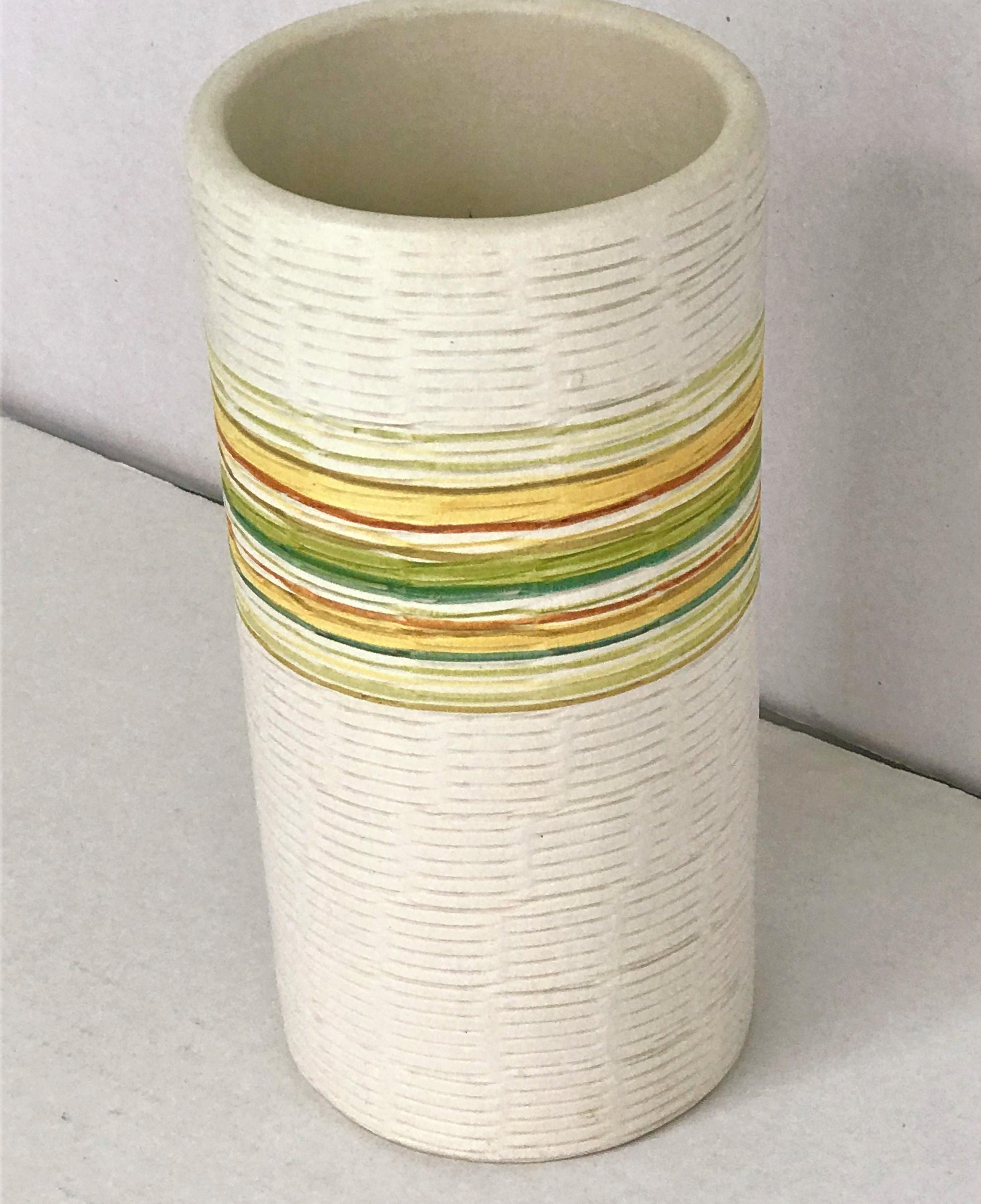 1960s Raymor pottery vase produced by Bitossi, probably designed by Aldo Londi, in Italy. With a design of incised striped with colored bands of moss green, lime green, yellow, mustard, tan and burnt orange on a creamy white background. A beautiful