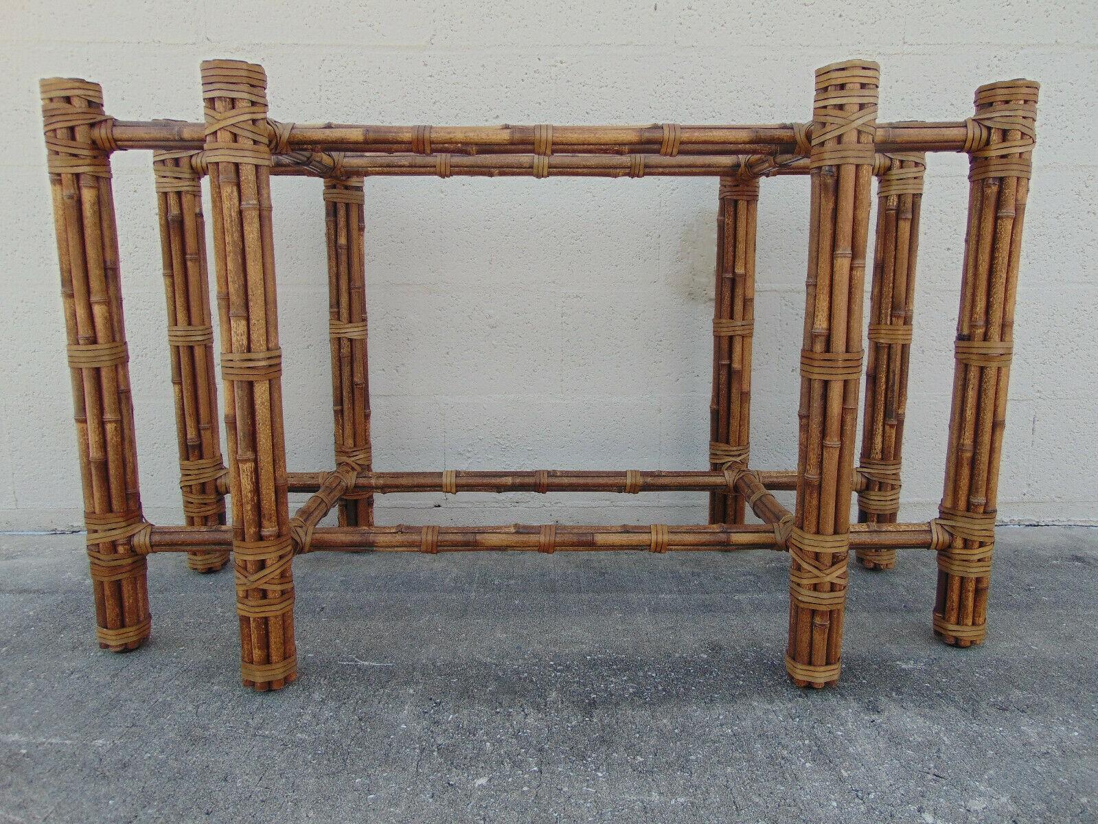Beautiful, naturally speckled bamboo dining table base designed by John McGuire. Created for use with a rectangular glass top, the base features bamboo poles lashed together with McGuire's signature rawhide laces. Timeless design and excellent