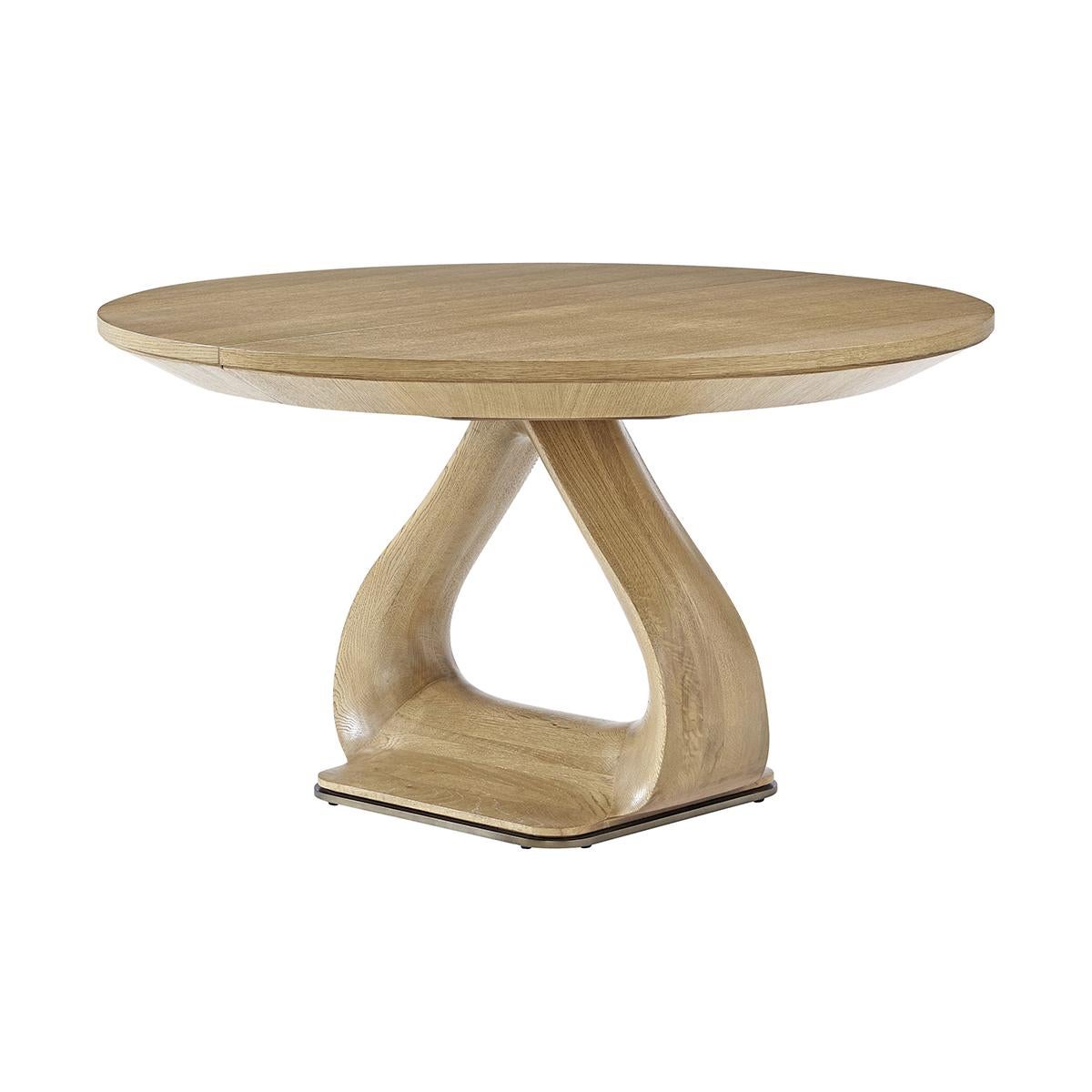 Masterfully crafted from oak, and finished in a fine blonde oak finish, this table showcases the natural beauty of the wood through its gentle, soft lines and a knife-edge top, creating a sophisticated and inviting atmosphere.

Featuring a unique
