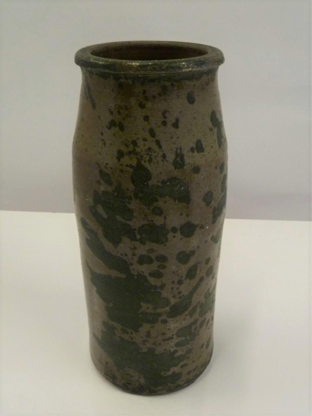 Very organic and rustic modern this early 20th century American salt glaze pottery crock vase is a beauty and would complement any style choice. Hand thrown pottery and glazed with the salt glaze technique with patches of unglazed greenish black