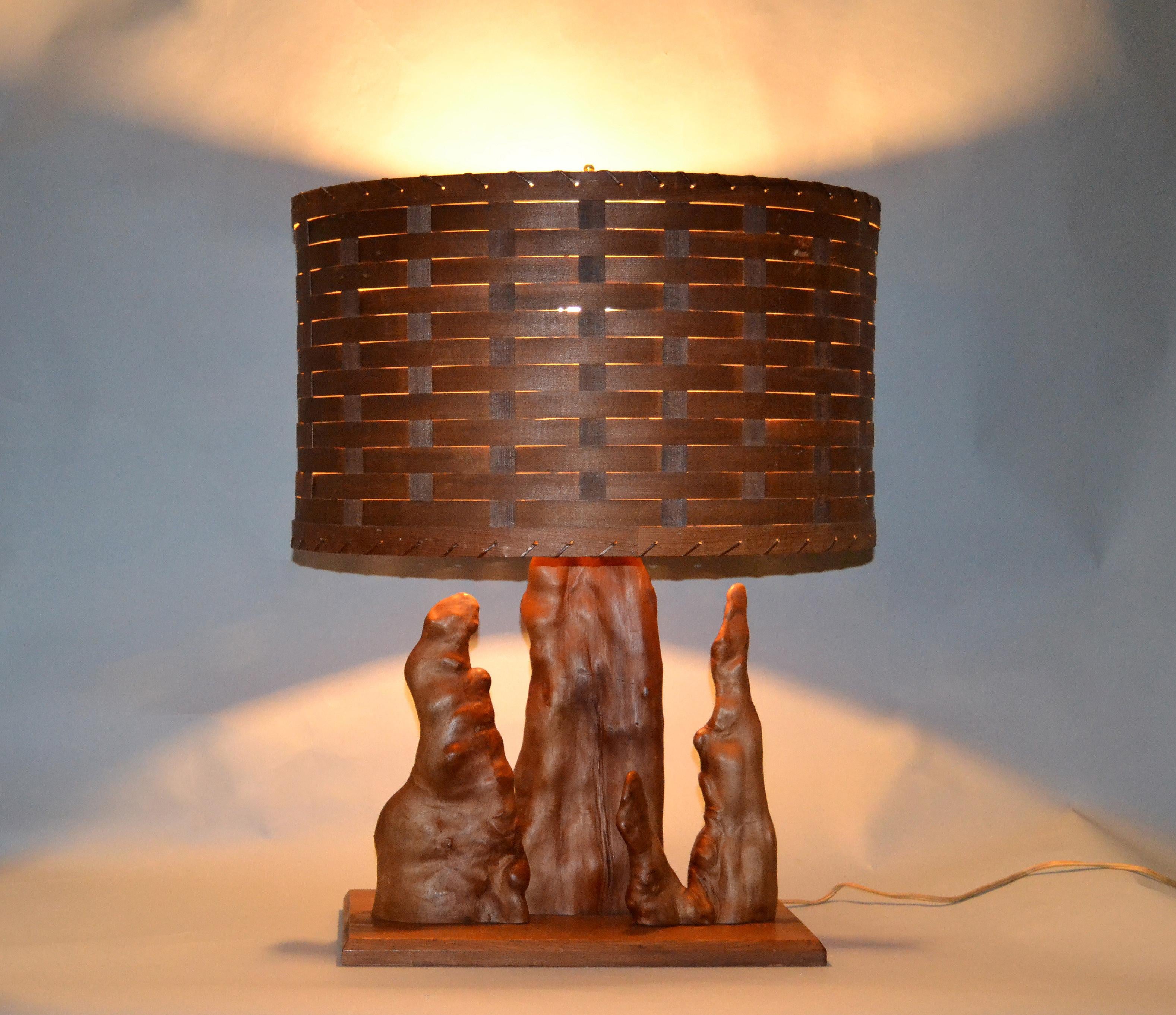 Organic modern sculptural driftwood table lamp with handwoven basket shade mounted on a cedar base.
In perfect working condition and uses a max 75 watts light bulb.
Shade measurements:
19 inches x 13 inches x 11.25 inches height.