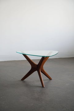 Organic modern sculptural side table with glass top, walnut base