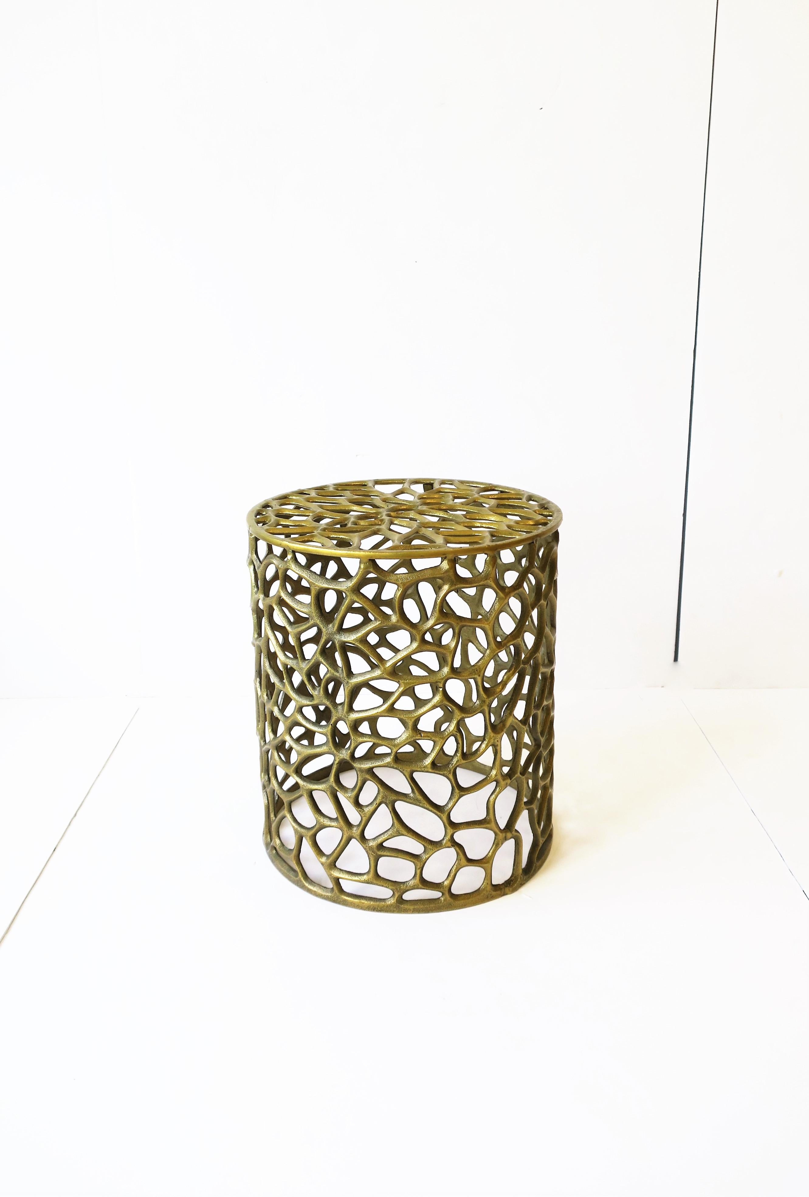 A small organic modern style gold tone brass-plated pedestal side or drinks table with perforated design. Table is a convenient size measuring: 13.25