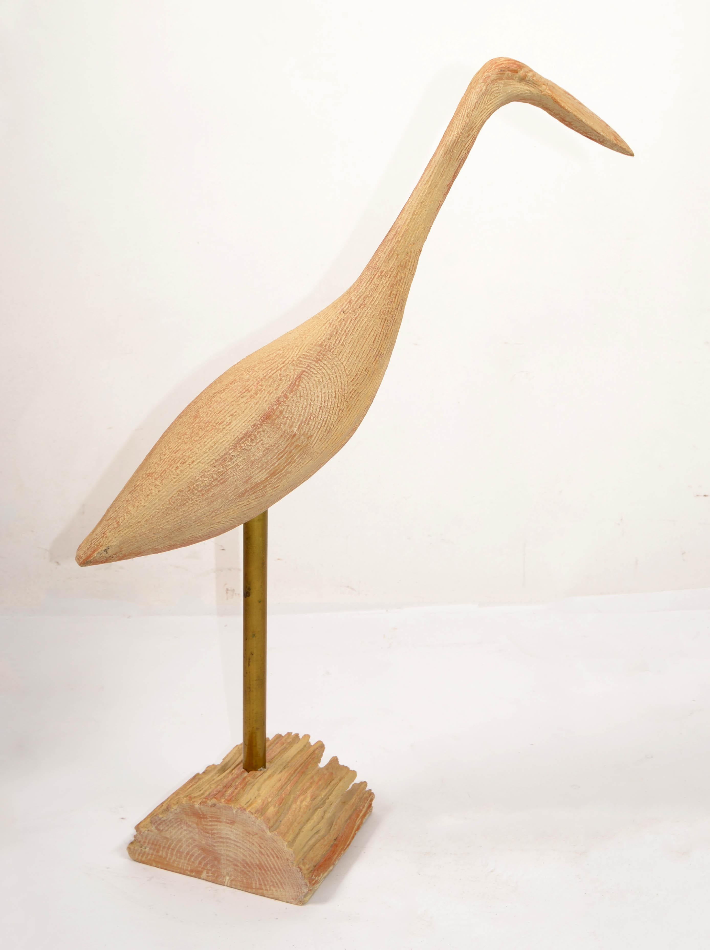 Organic Modern vintage carved Wood and Brass Egret Sculptures on hardwood base made in Indiana by Milton Collection Inc.
Features a handmade chiseled Harewood Egret Bird Sculpture mounted on a Brass Tubular Rod on a raw wood piece. 
Green Felt Cover