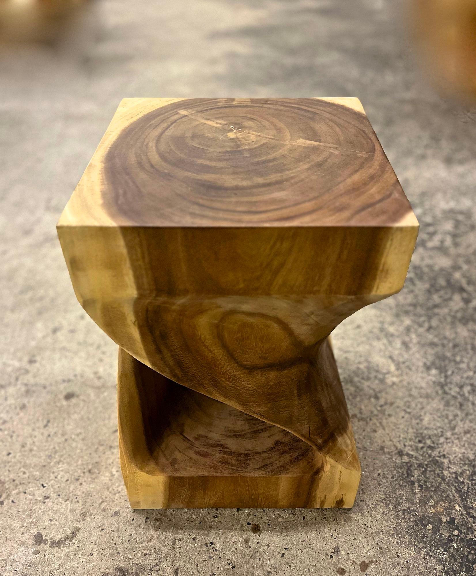Extraordinary Suar wood side table or stool, artfully handcrafted by a very talented indonesian artist. This organic modern side table/ stool impresses with its beautiful twisted, open worked design which has been elaborately worked out of one big