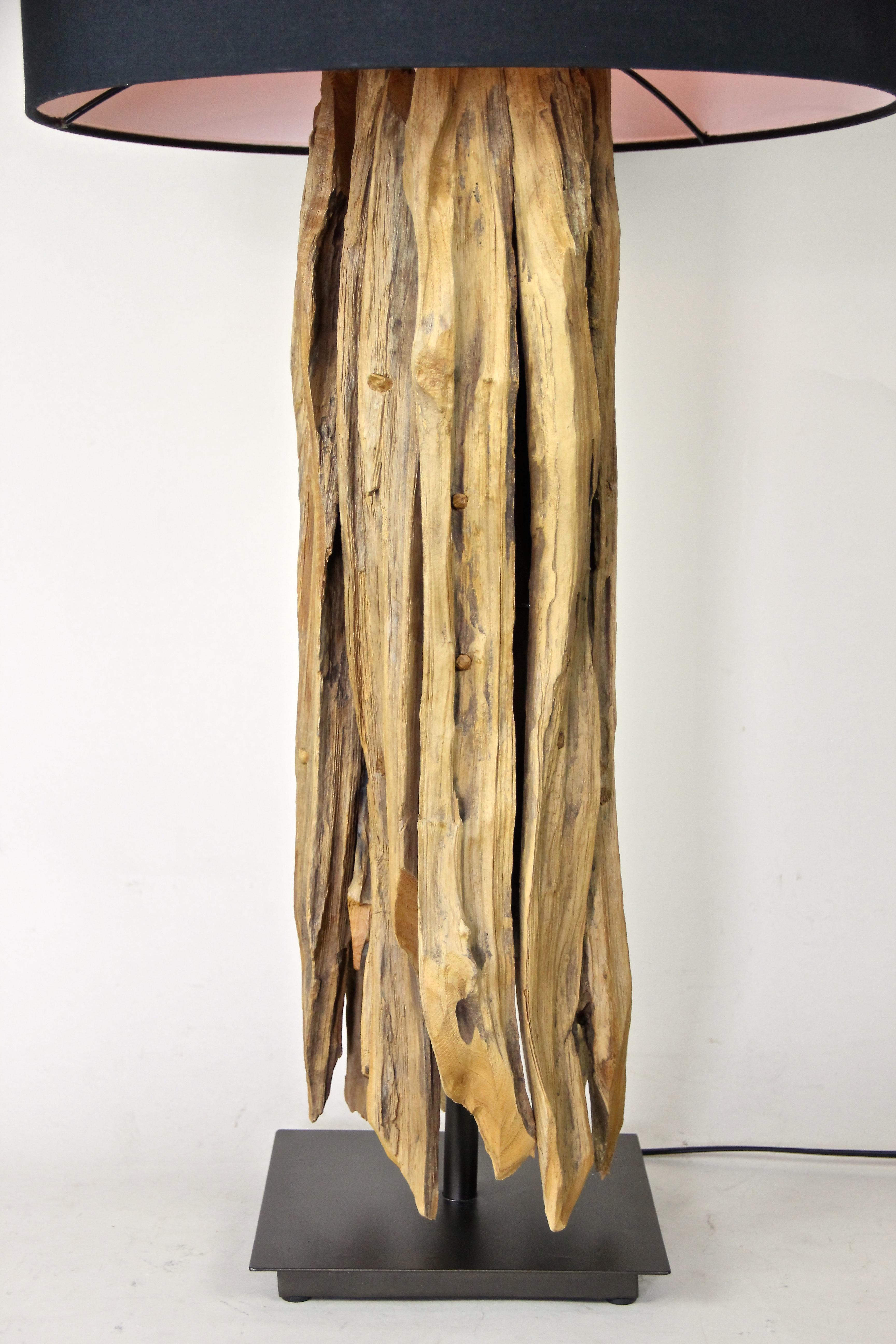 Charming organic modern table lamp with old driftwood and a round greyblue lampshade. Standing on a 8.7
