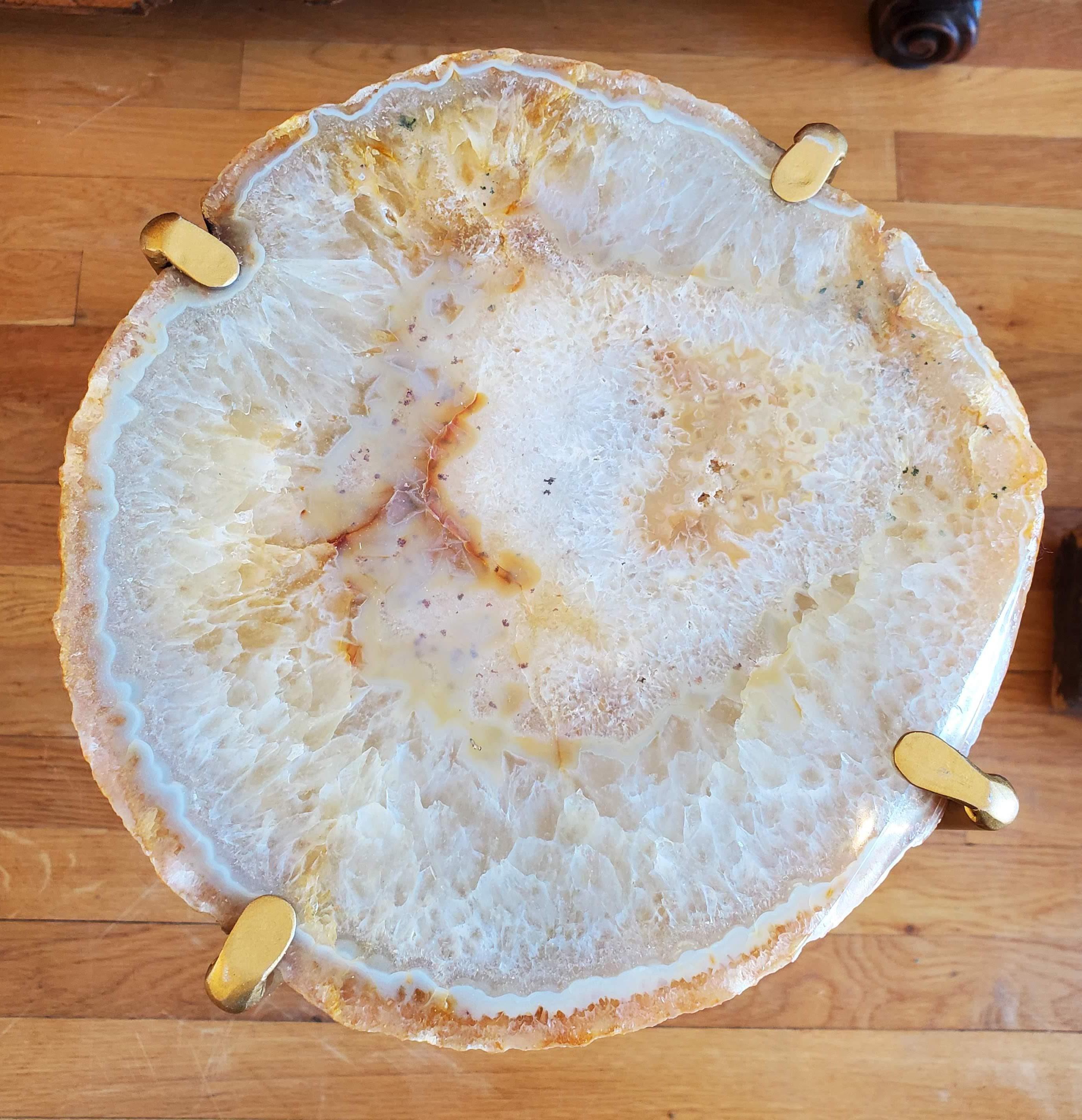 Our gorgeous geode drink tables are a perfect addition to any sitting room especially in an area where the sun hits them just right. Handcrafted with one of a kind quartzite slabs and gold gilt metal, this table is available as pictured or can be