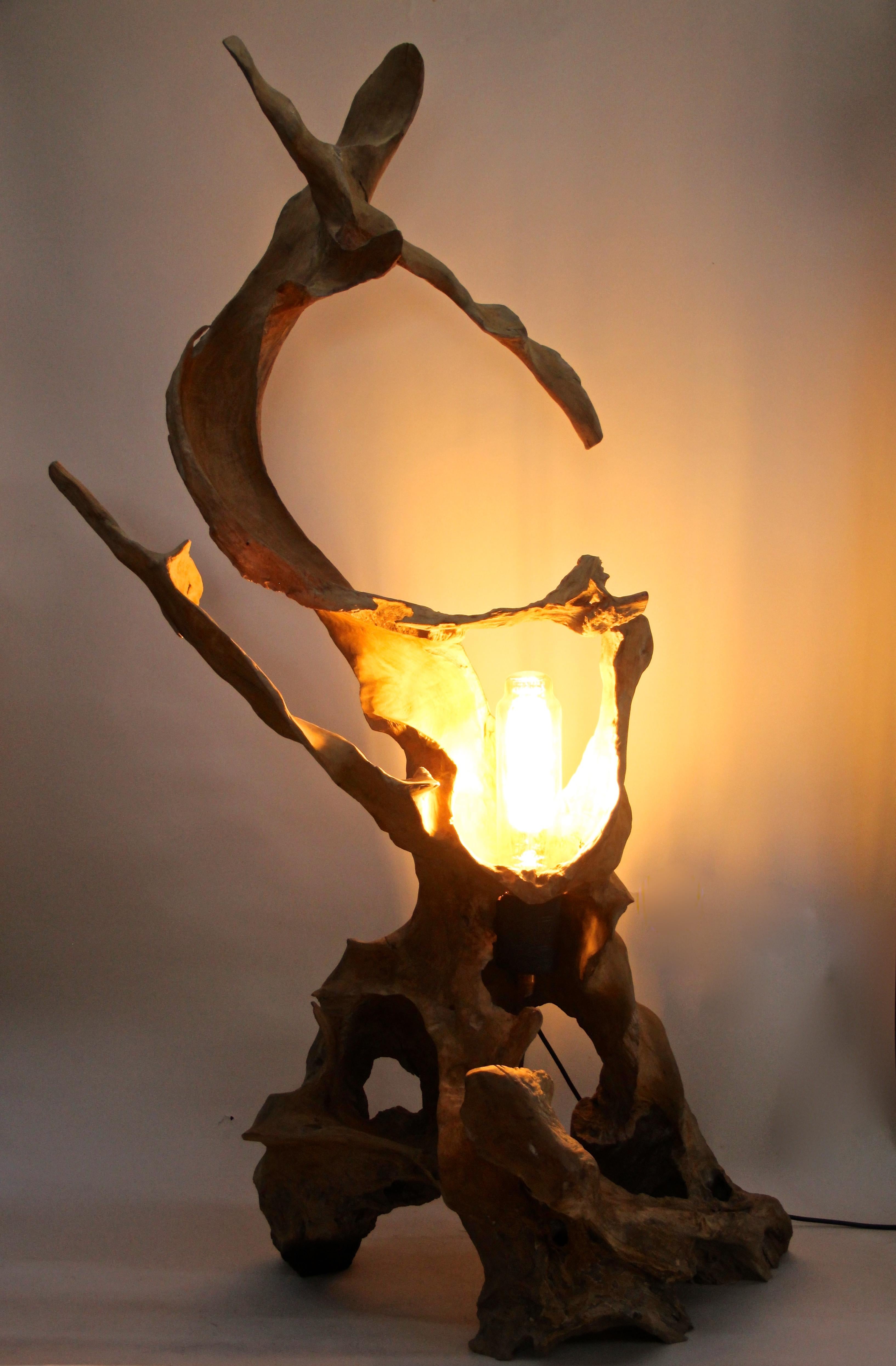 Out of the ordinary teak root floor lamp with special LED bulb. Made of a carefully selected large old teak root, this modern wooden floor lamp impresses with its great organic look. A large special LED lightbulb was perfectly set in the middle of