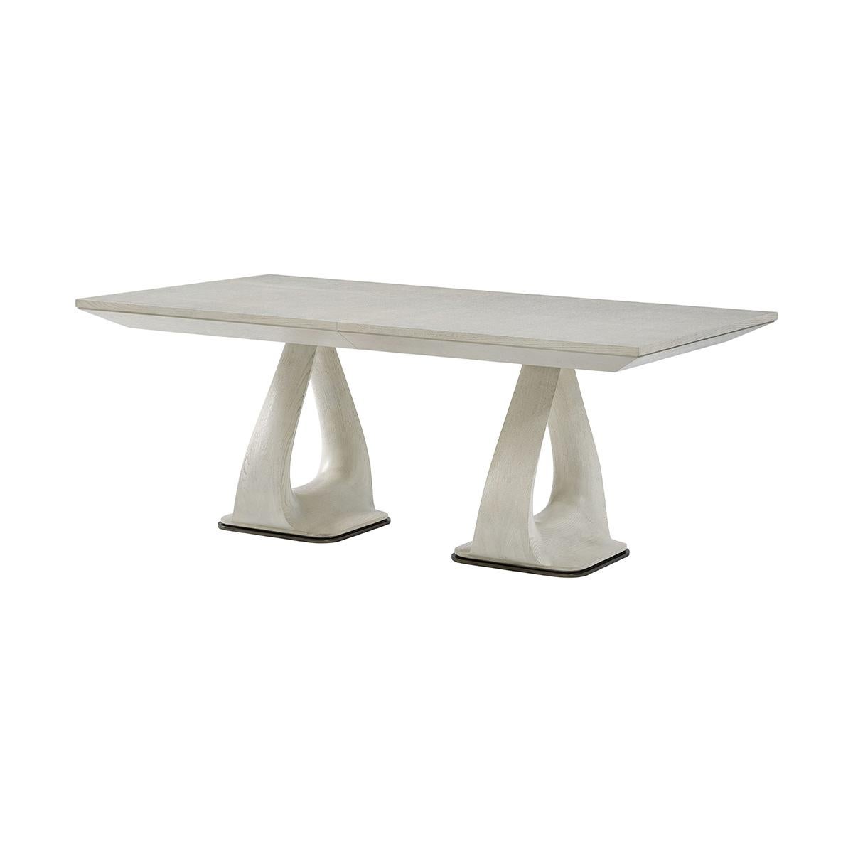 Masterfully crafted from oak, and finished in opal white finish, this table showcases the natural beauty of the wood through its gentle, soft lines and a knife-edge top, creating a sophisticated and inviting atmosphere.

Featuring a unique shaped