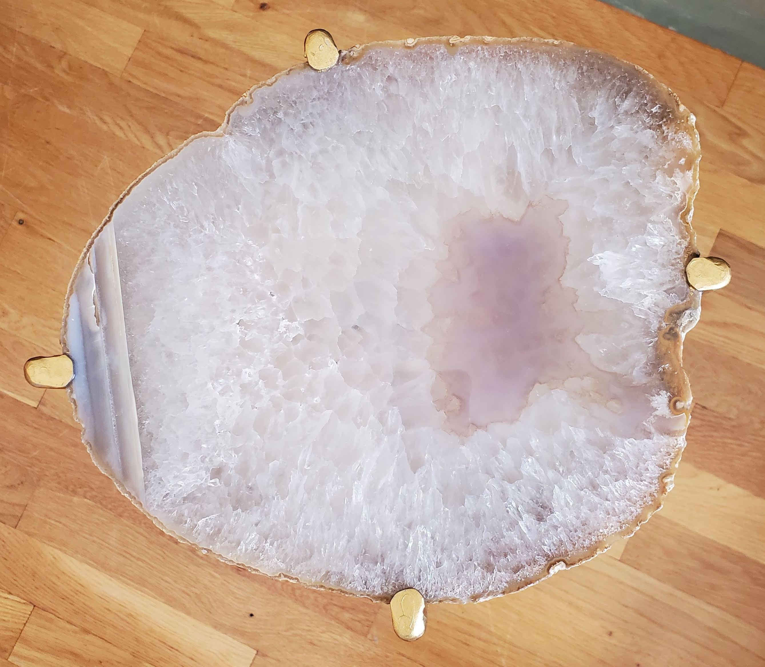 Our gorgeous geode drink tables are a perfect addition to any sitting room especially in an area where the sun hits them just right. Handcrafted with one of a kind quartzite slabs and gold gilt metal, this table is available as pictured or can be