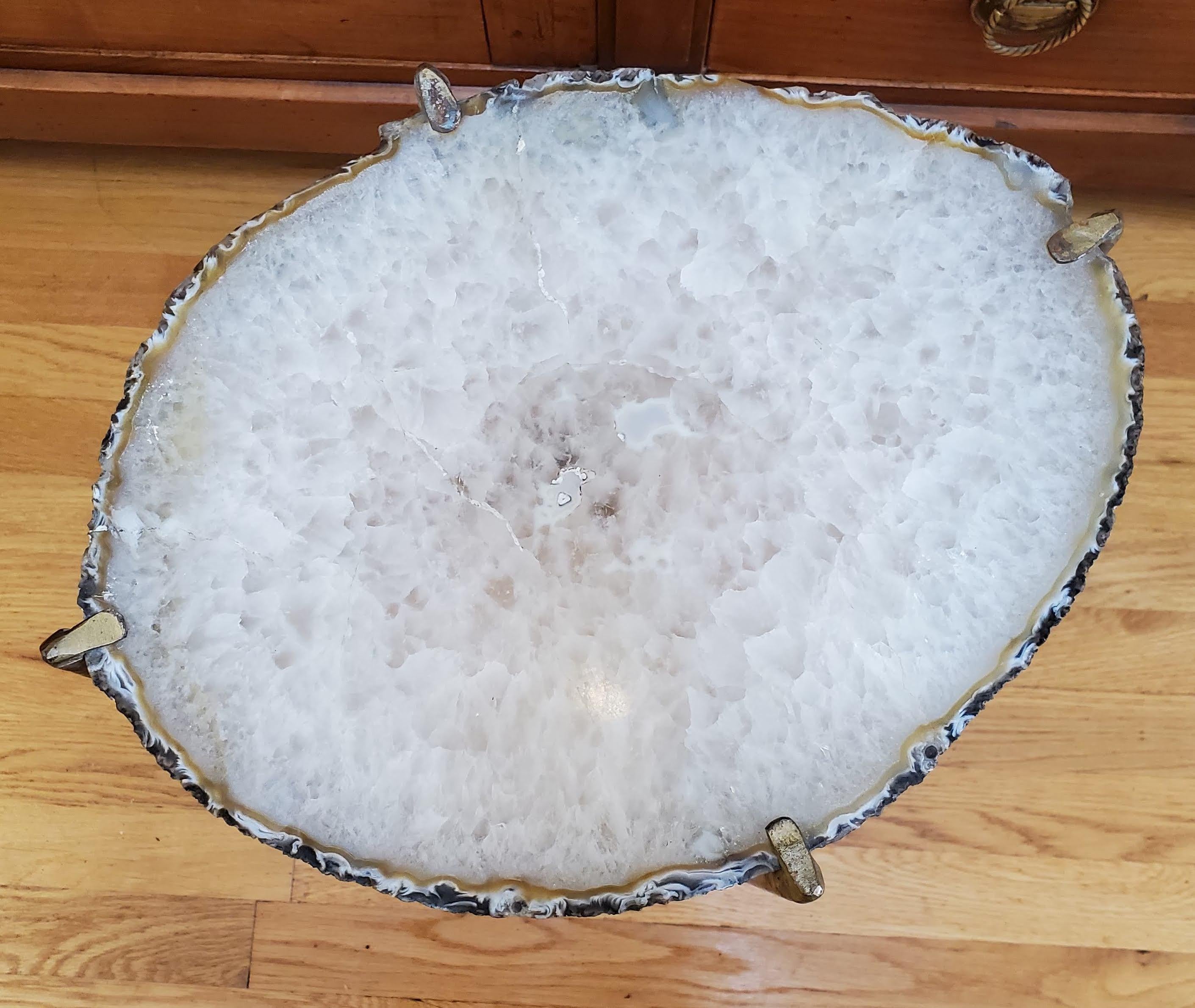 Our gorgeous geode drinks table is a perfect addition to any sitting room especially in an area where the sun hits them just right. Handcrafted with one of a kind geode slabs and gold gilt metal. this table is available as pictured or can be