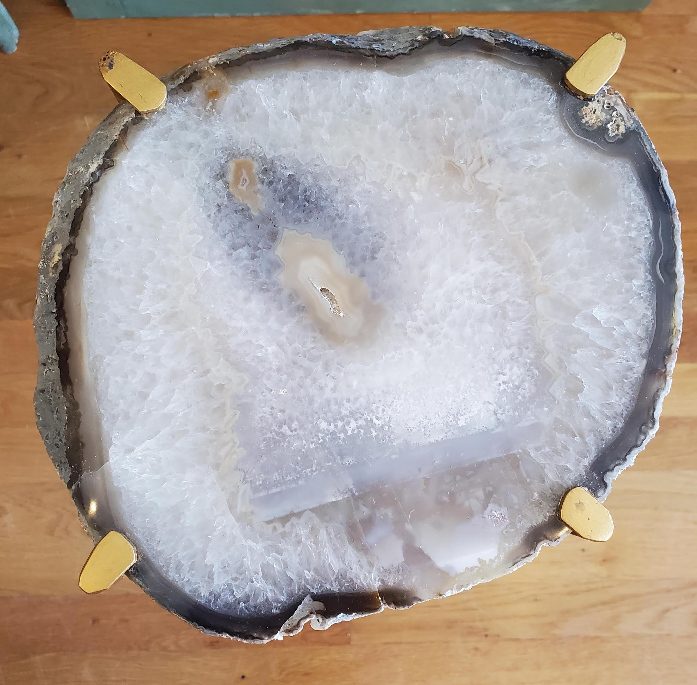 Our gorgeous geode drink tables are a perfect addition to any sitting room especially in an area where the sun hits them just right. Handcrafted with one of a kind quartzite slabs and gold gilt metal. This table is available as pictured or can be